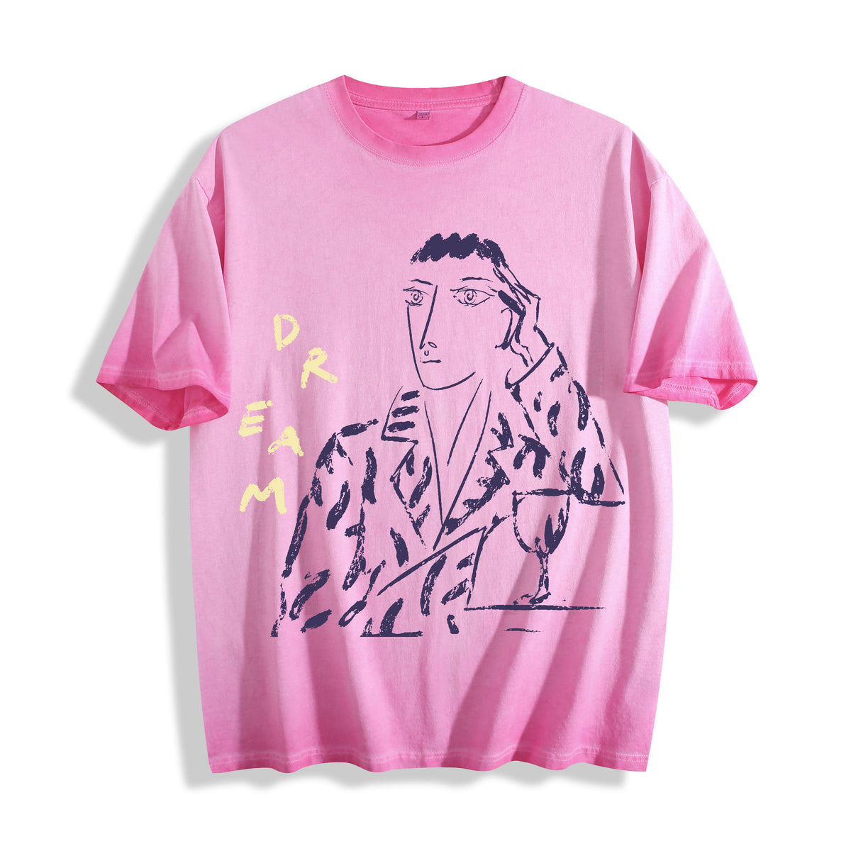 Top-down flat lay view of an aura pink heavyweight boxy fit streetwear t-shirt displaying a raw charcoal daydreamer sketch graphic.