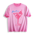 Flat lay product photography of an aura pink heavyweight boxy fit t-shirt showcasing a bold raw ink stroke martini glass sketch and blue typography.