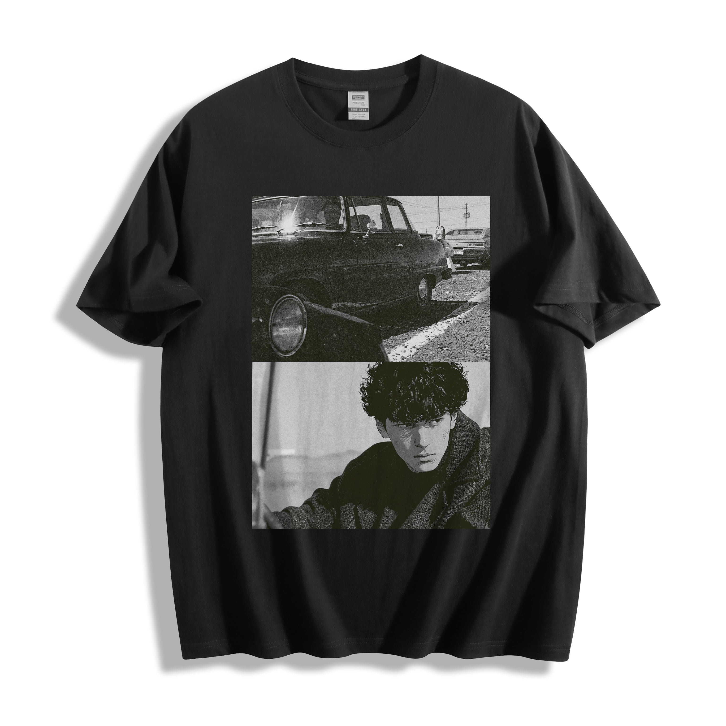 Top-down flat lay view of a black heavyweight boxy fit streetwear t-shirt displaying a striking hardboiled Yakuza cinema car and lone-wolf split-panel design.