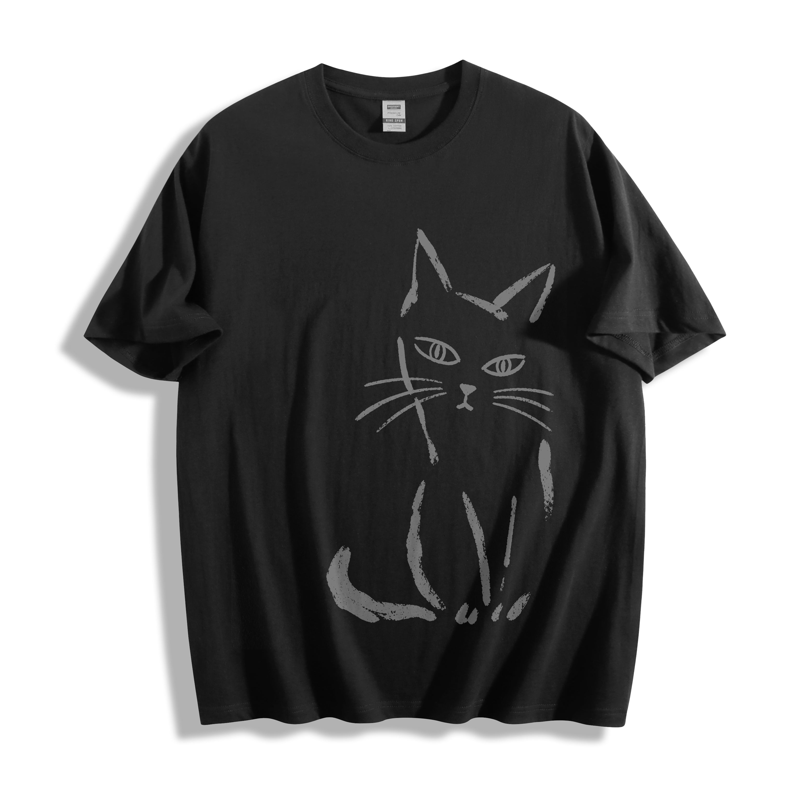 Top-down flat lay view of a black heavyweight boxy fit streetwear t-shirt displaying a striking white paint stroke judgmental side-eye cat design.