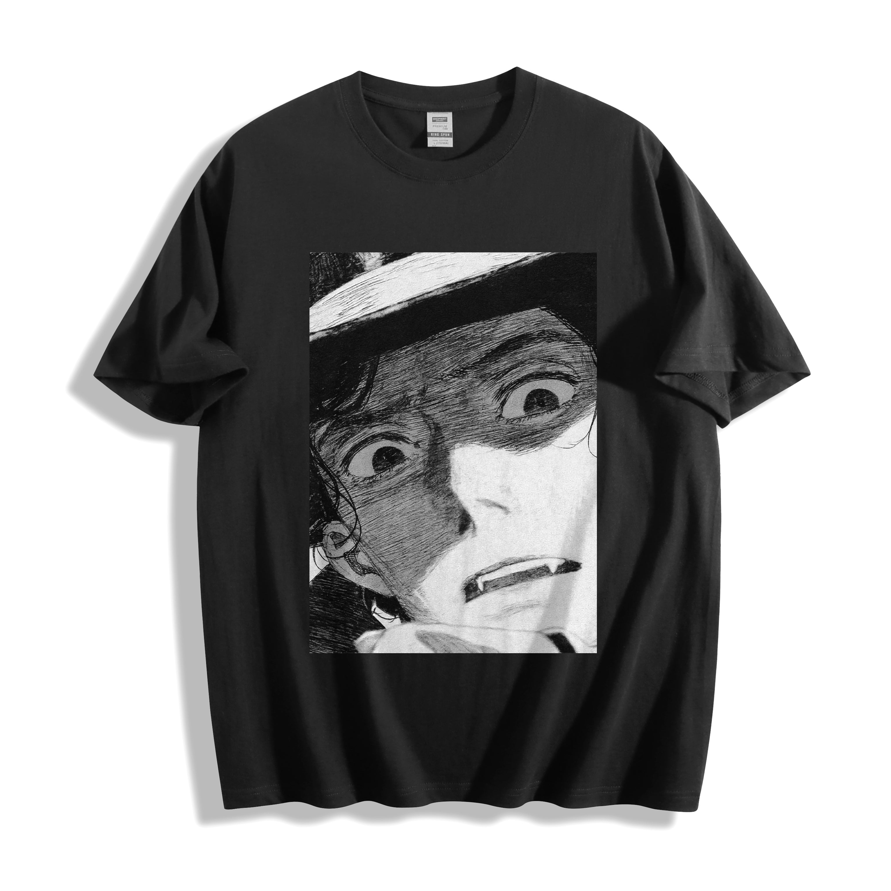 Top-down flat lay view of a black heavyweight boxy fit streetwear t-shirt displaying a striking monochrome shocked manga face illustration.