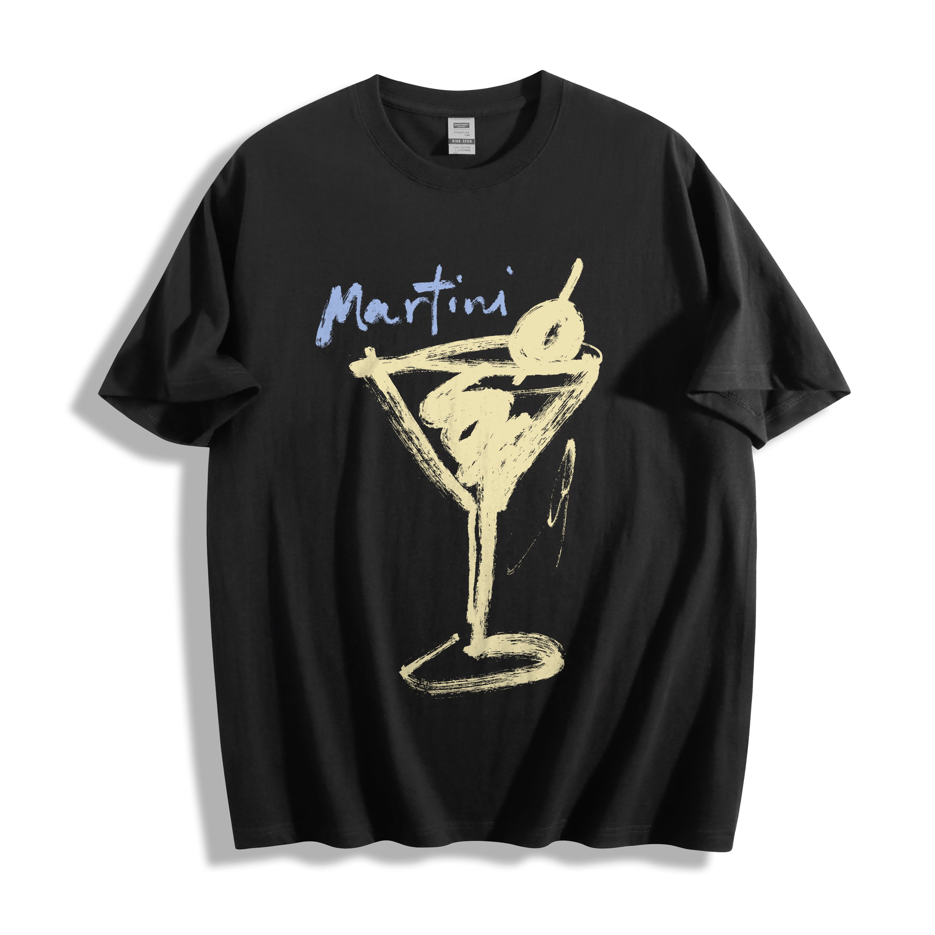 Clean flat lay product shot of a black t-shirt showcasing a bold minimalist martini glass line art illustration and the word 'Martini' in blue, displayed against a clean white background.