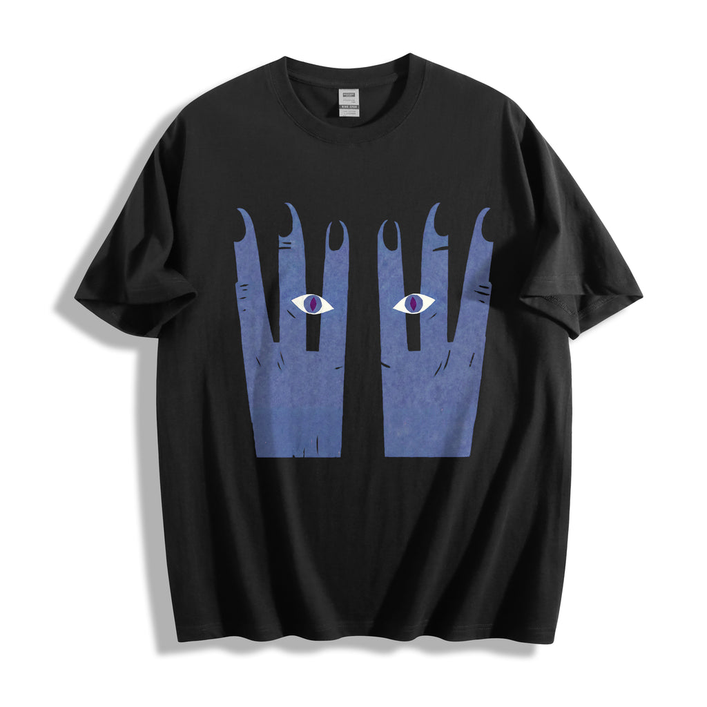A black short-sleeve t-shirt with a bold surrealgraphic print of two blue hands with eyes on the front, displayed against a clean white background.