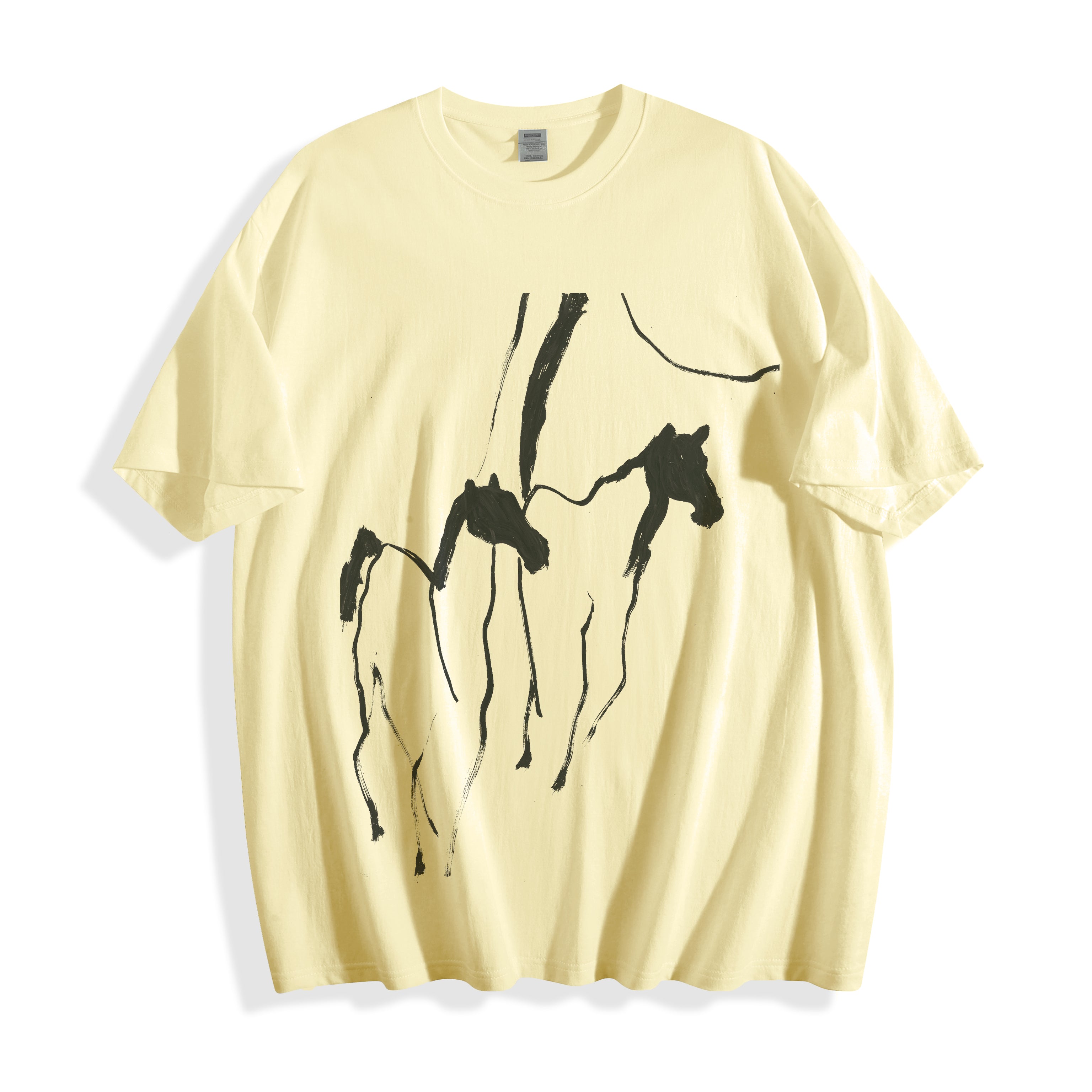 Top-down flat lay view of a butter yellow oversized streetwear t-shirt displaying a striking abstract brush stroke running horses design.