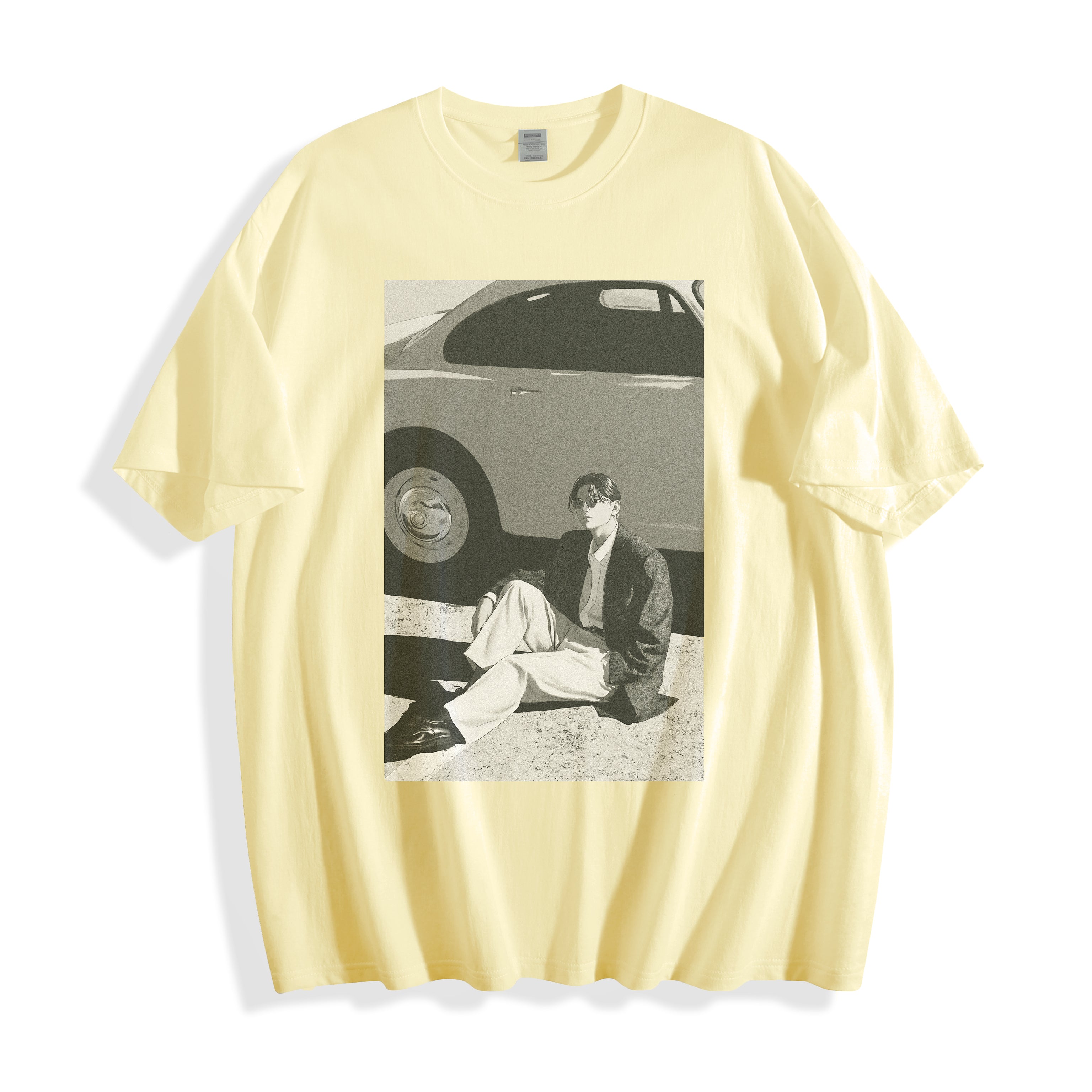 Flat lay presentation of a butter yellow oversized casual t-shirt featuring a striking 90s retro cinematic photography design, showing a person sitting next to a car, displayed on a clean white background.