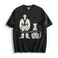 A flat lay of a black dissociating ironic graphic tee, contrasting a dark background with the high-contrast sarcastic meme streetwear print.