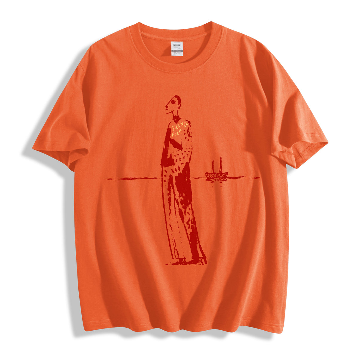 A flat lay of an orange mysterious elongated figure line art graphic tee, combining a vibrant colorway with raw, indie art inspired streetwear design.