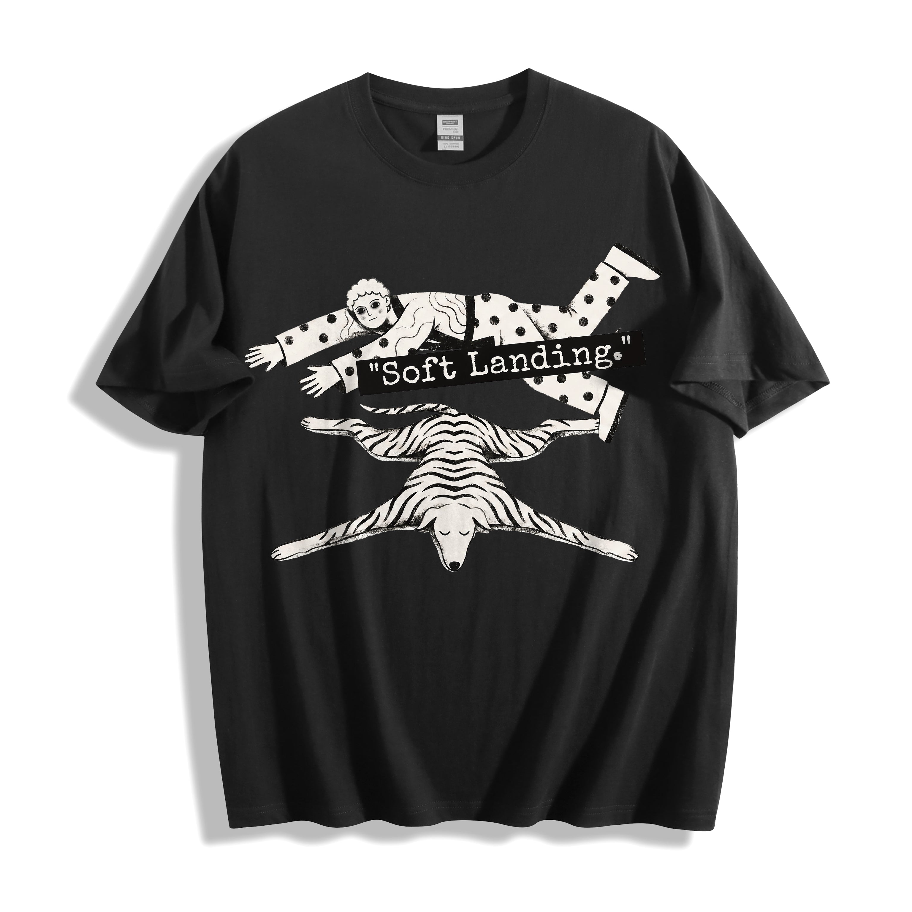 A flat lay of a black face down soft landing graphic tee, contrasting a dark base with the minimalist and deadpan face down design.