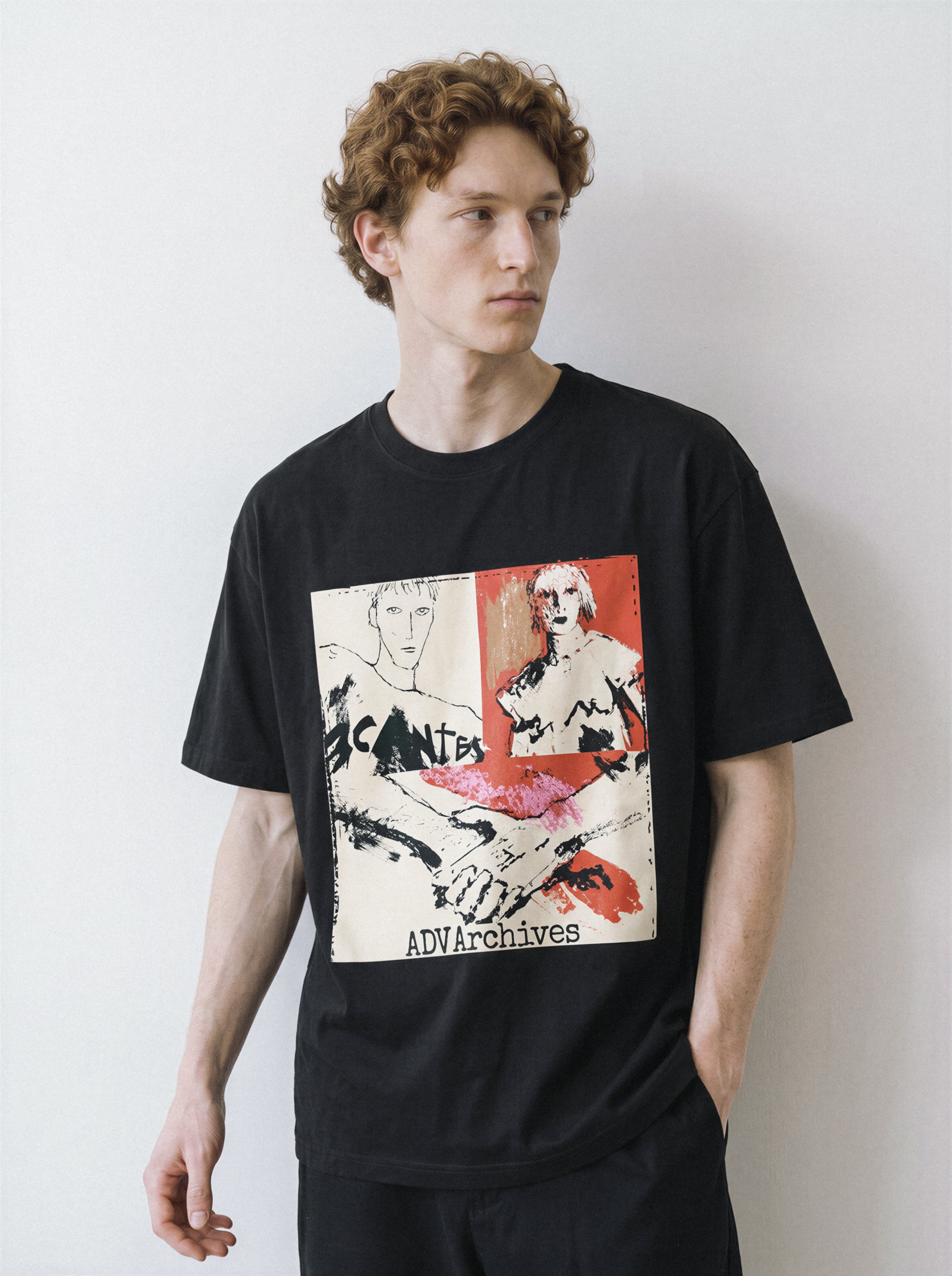 A male model looking away wearing a black handshake portrait mixed media graphic tee, emphasizing the relaxed unisex fit and striking indie art aesthetic.