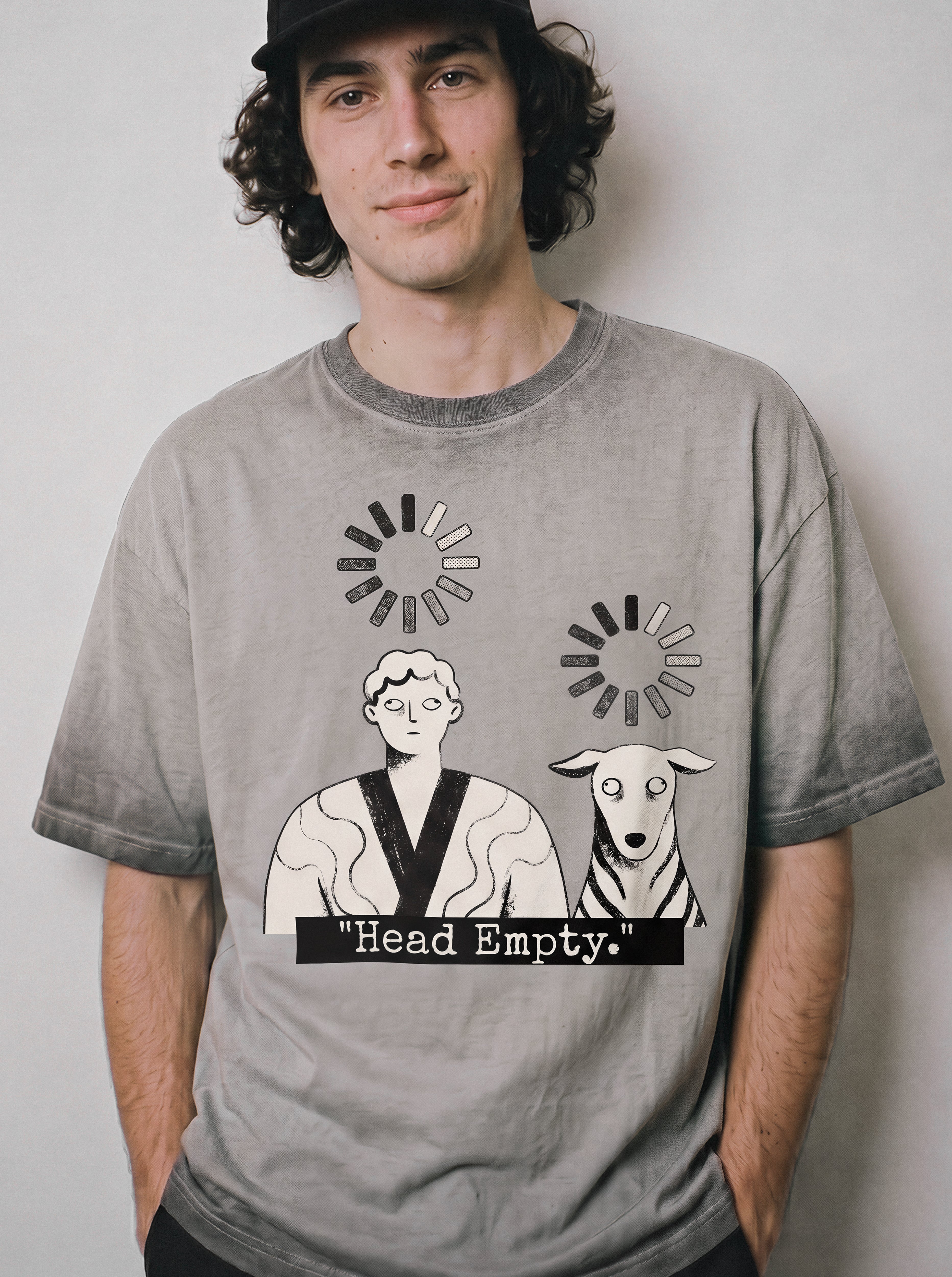 A male model with hands in pockets wearing an ombre grey head empty buffering icon graphic tee, displaying the minimalist loading screen apparel style.