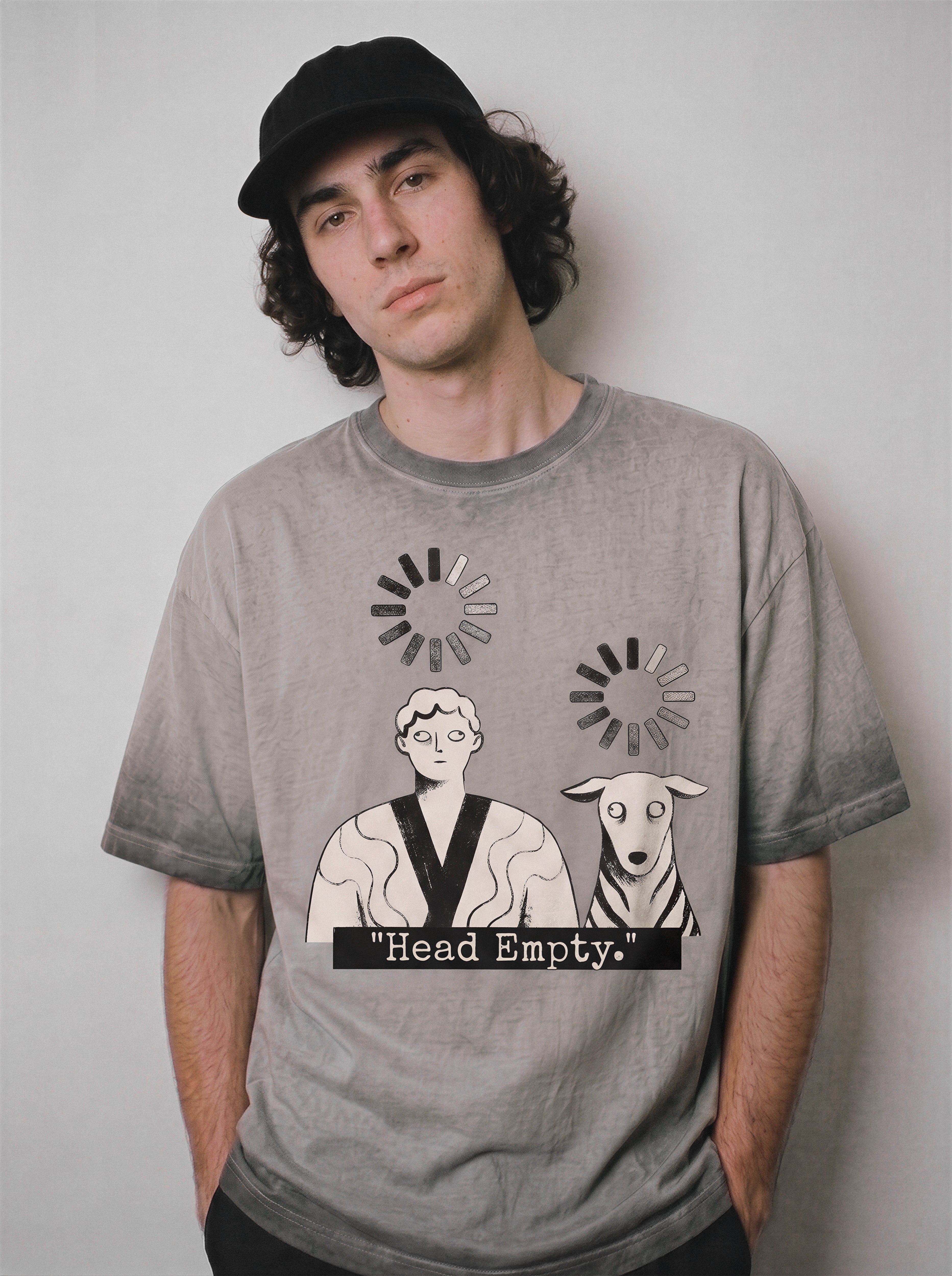 A front view of a male model wearing an ombre grey head empty buffering icon graphic tee, highlighting the system crash illustration and boxy fit.