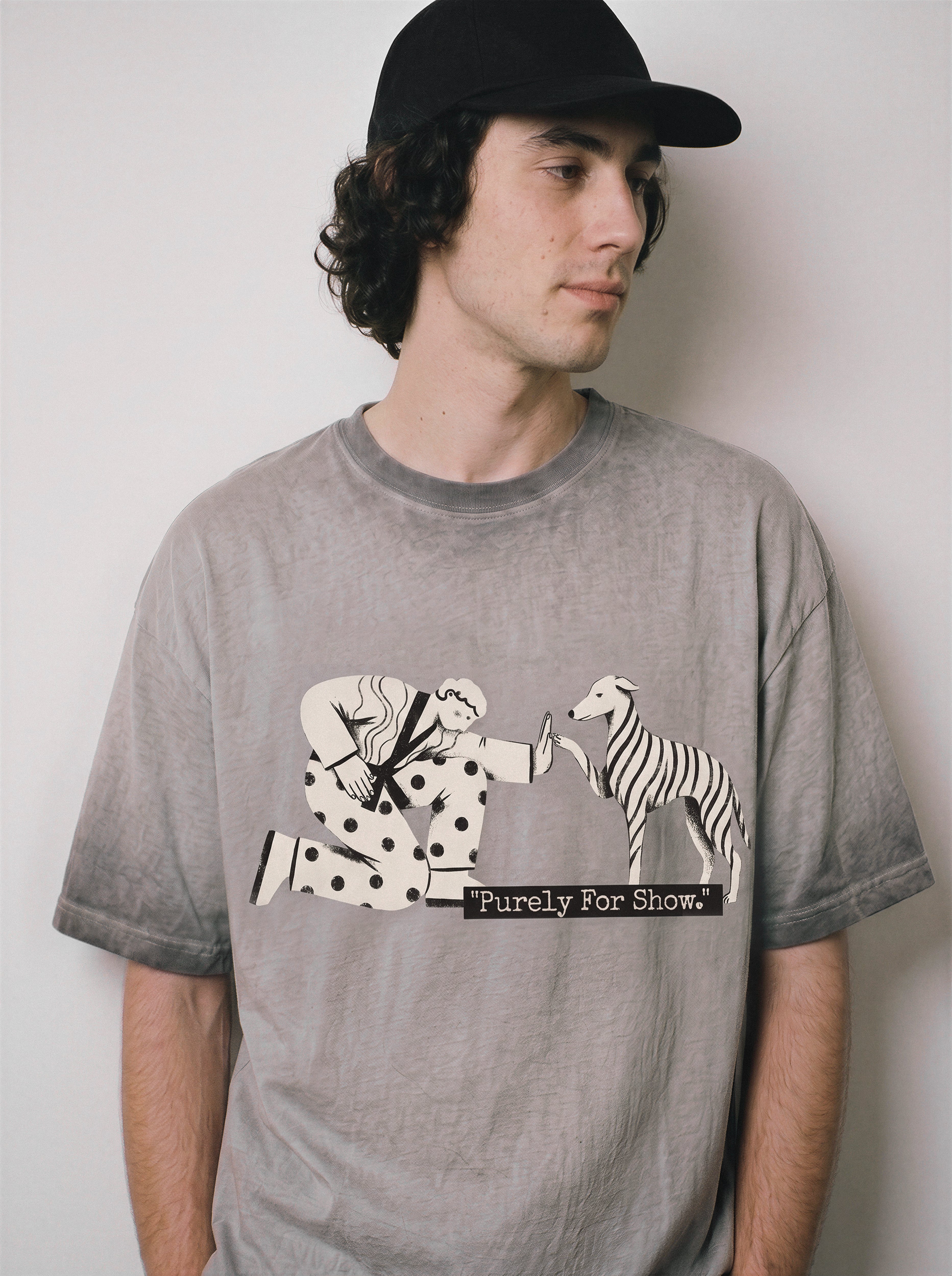 A male model looking away wearing an ombre grey ironic high five graphic tee, emphasizing the relaxed boxy fit and sarcastic introvert streetwear aesthetic.