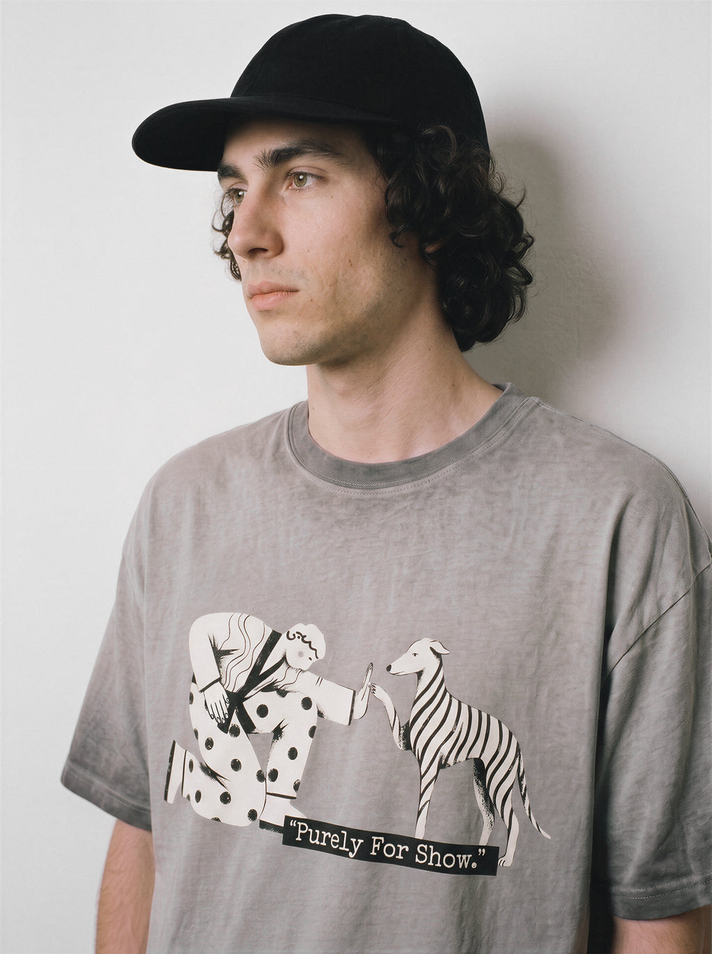 A side profile of a male model wearing an ombre grey ironic high five graphic tee, featuring the sarcastic boy and dog print and tired of fakeness mood.