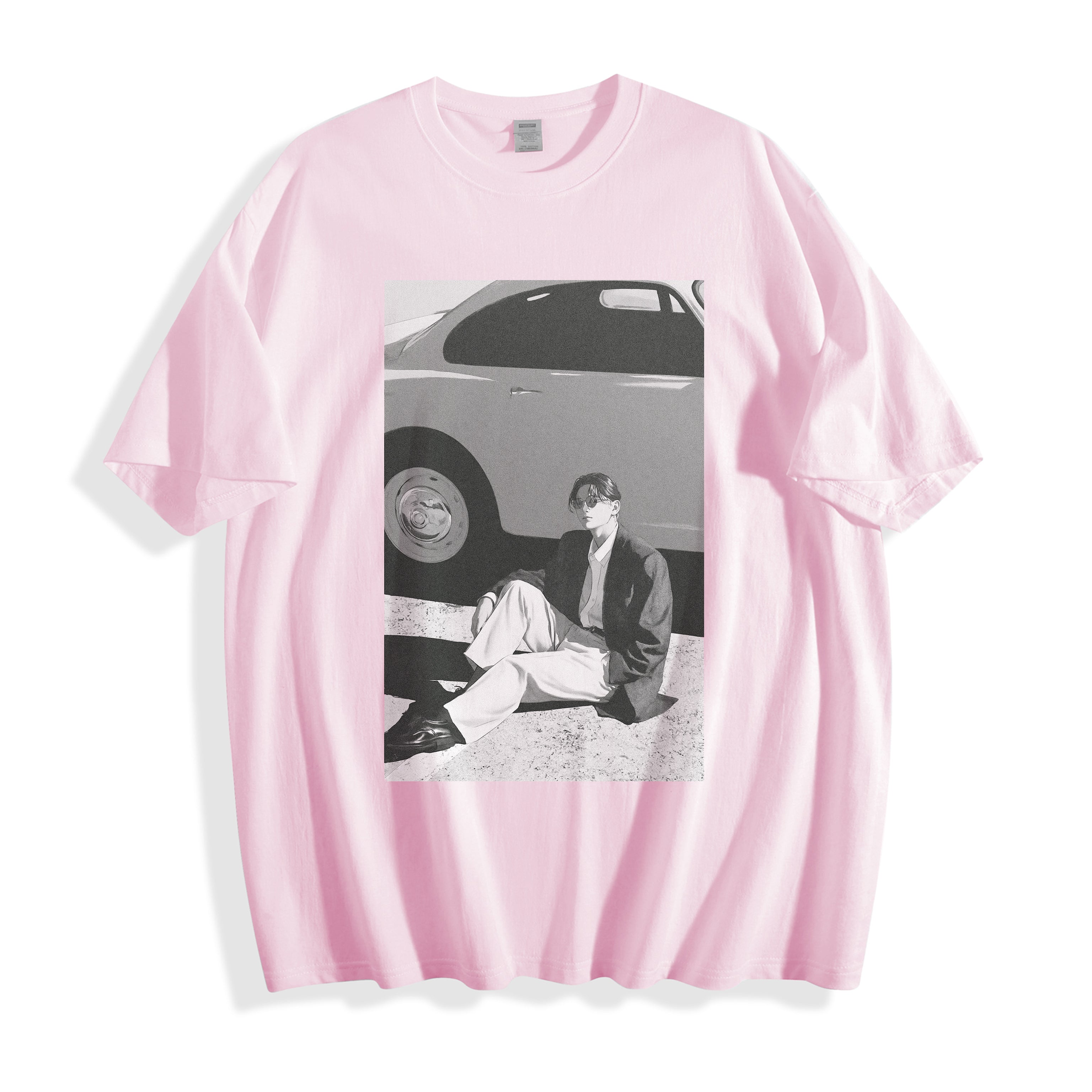 Product flat lay of a light pink oversized unisex t-shirt showcasing a 90s retro black and white photography graphic,showing a vintage car and a seated person.