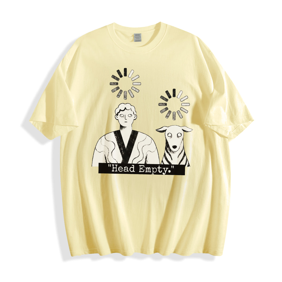 A flat lay of a butter yellow loading wheel graphic tee, combining a warm neutral base with the hopeless brain drain system crashed graphic design.