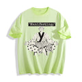 A flat lay of an acid lime manifesting meditating graphic tee, featuring the deadpan boy and dog line art print depicting a detached state of mind.