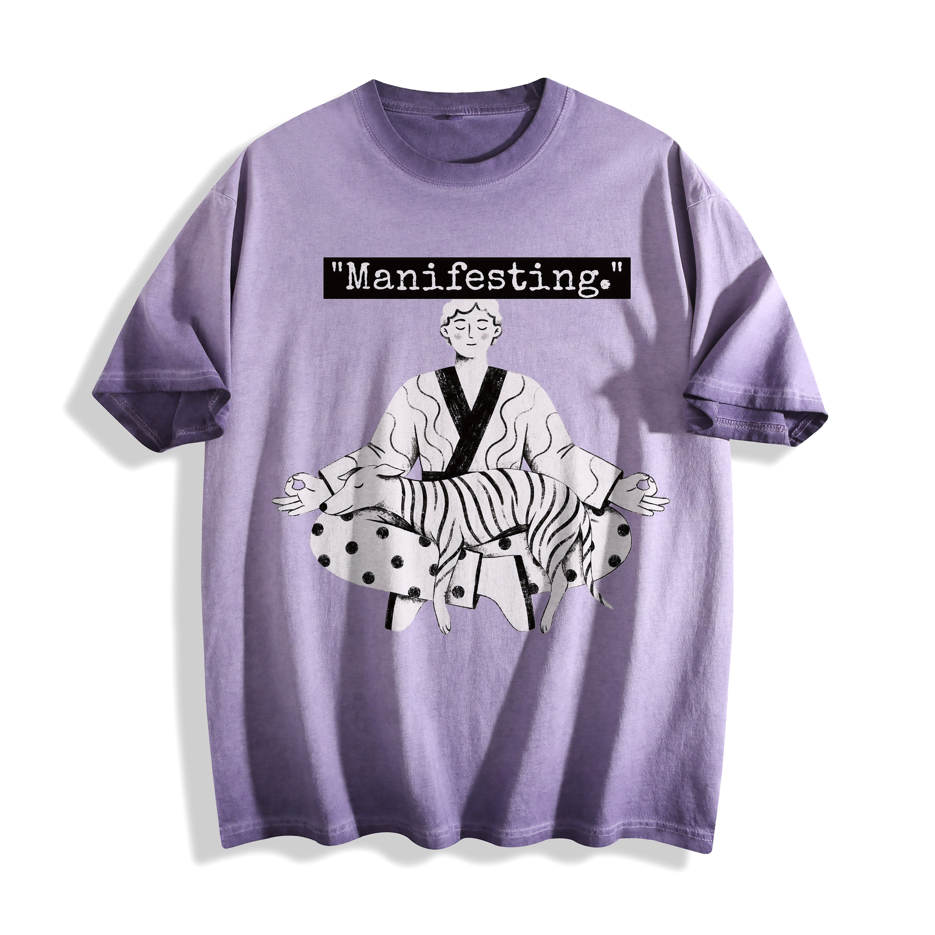 A flat lay of an ombre violet manifesting meditating graphic tee, blending a muted purple base with the minimalist manifesting line art graphic.