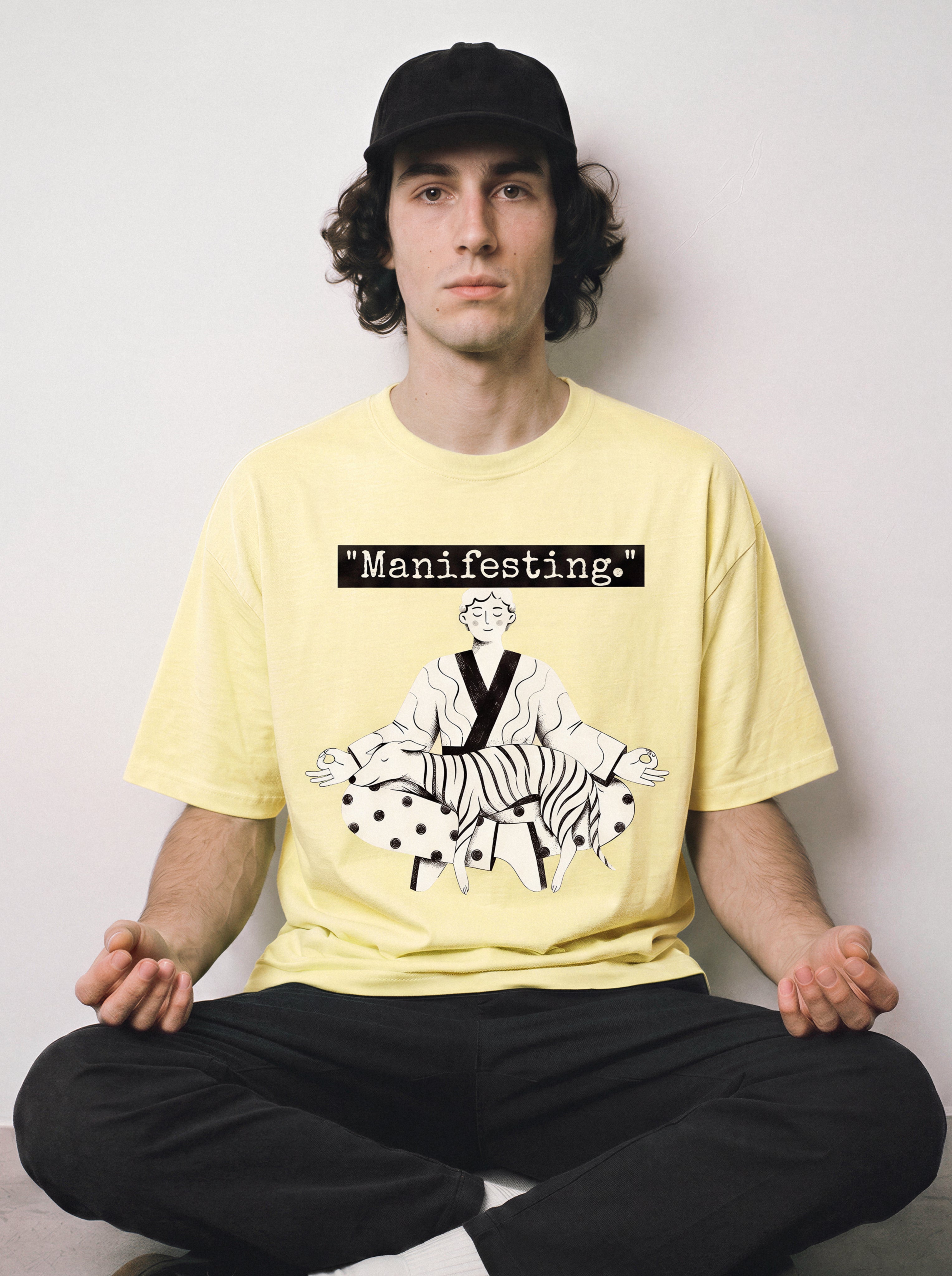 A male model sitting cross-legged wearing a butter yellow meditating boy and dog line art graphic tee, highlighting the pure line art form and minimalist streetwear vibe.