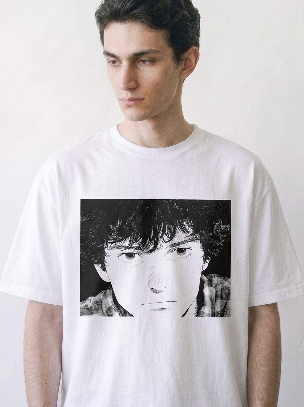 A male model looking away wearing a white messy hair manga portrait graphic tee, showcasing the nostalgic 90s retro anime aesthetic.