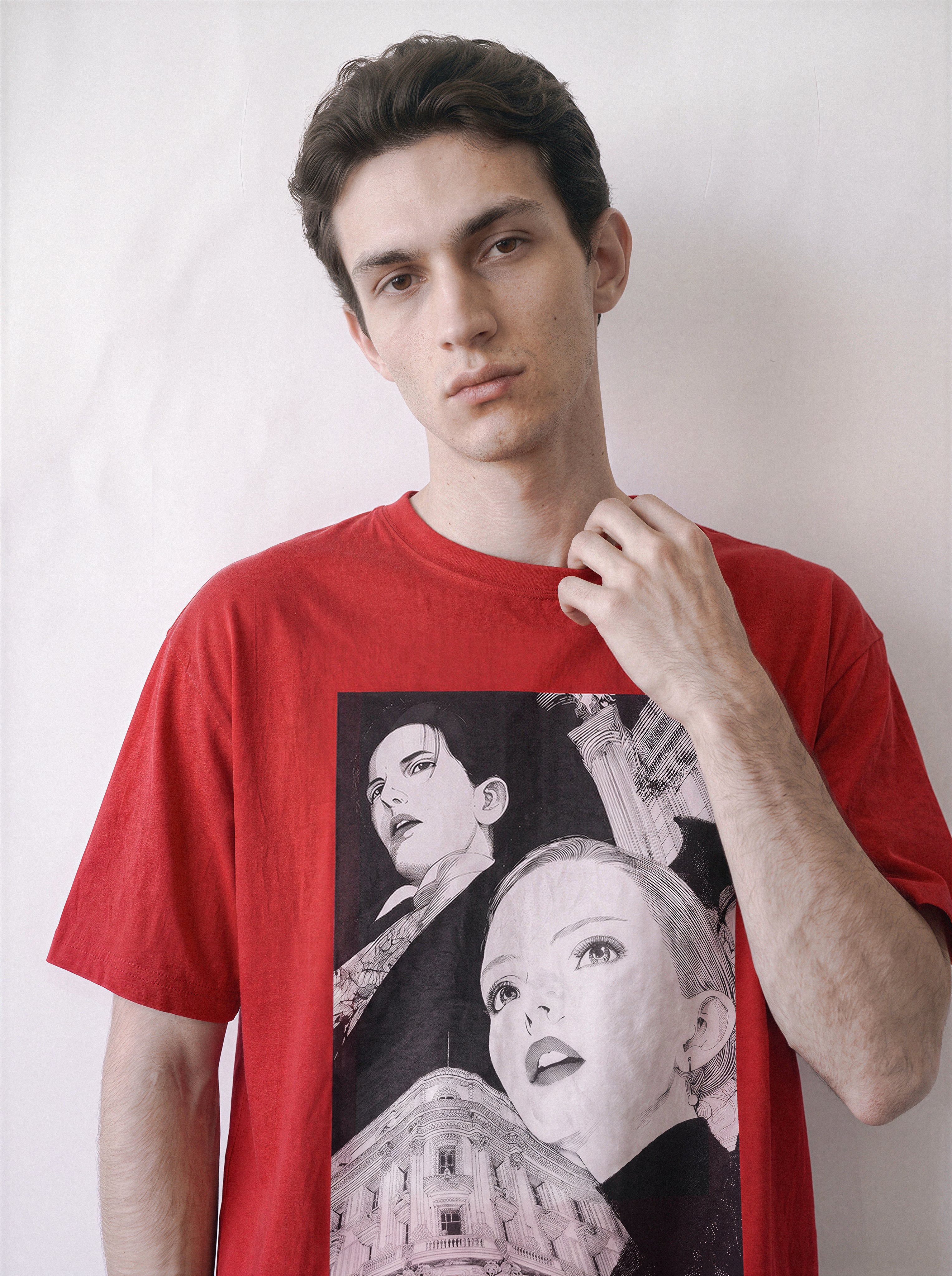 A male model with arms crossed standing front wearing a red monochrome upward gaze graphic tee, emphasizing the 1998 archive aesthetic and relaxed silhouette.