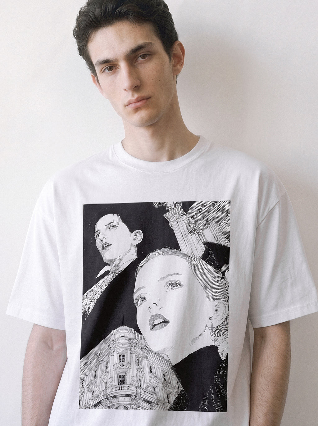 A male model with a tilted head wearing a white monochrome upward gaze graphic tee, capturing the delicate upward gazes facing an unknown century against classical architecture.