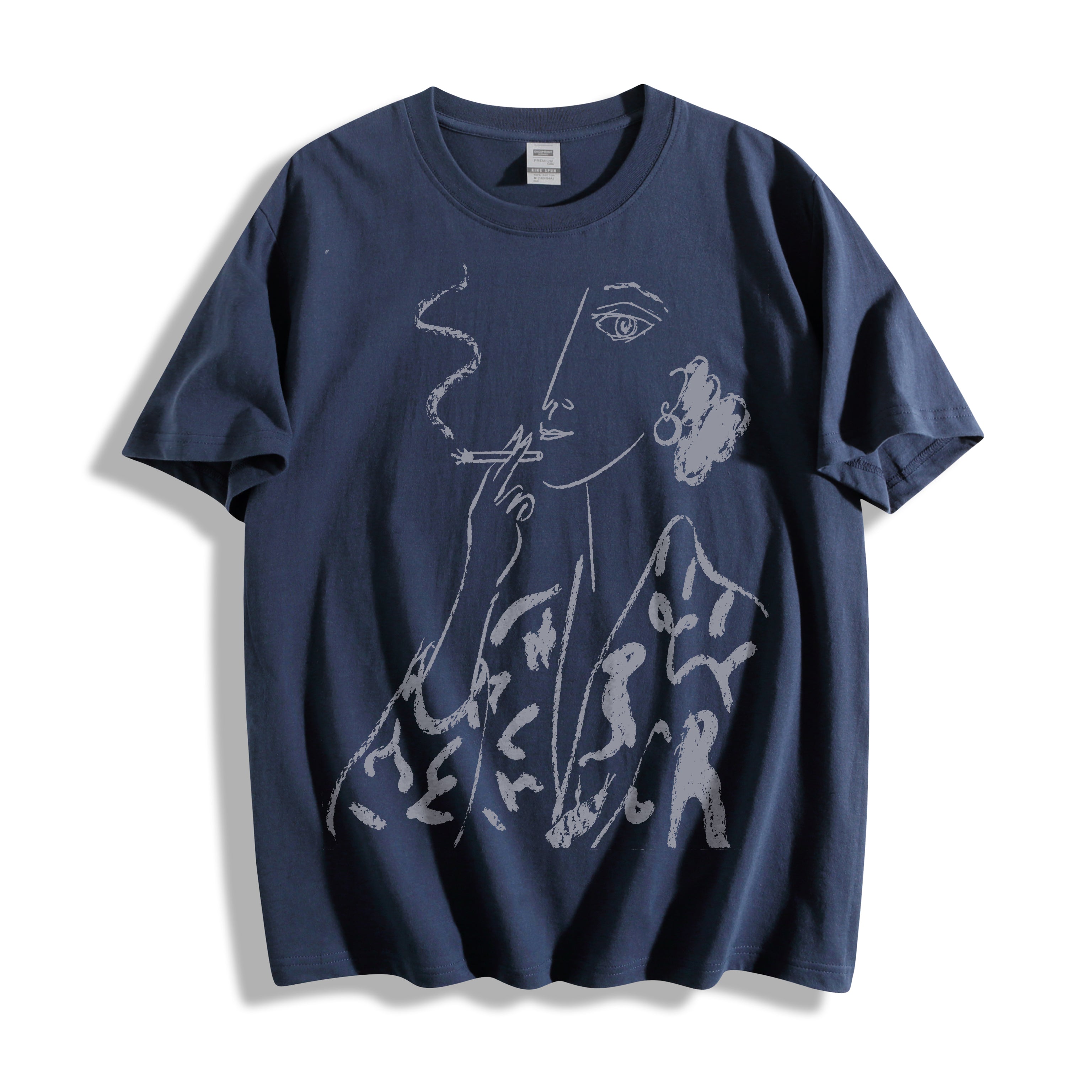 Clean flat lay product shot of a navy oversized graphic tee featuring a continuous line drawing of a smoking portrait.
