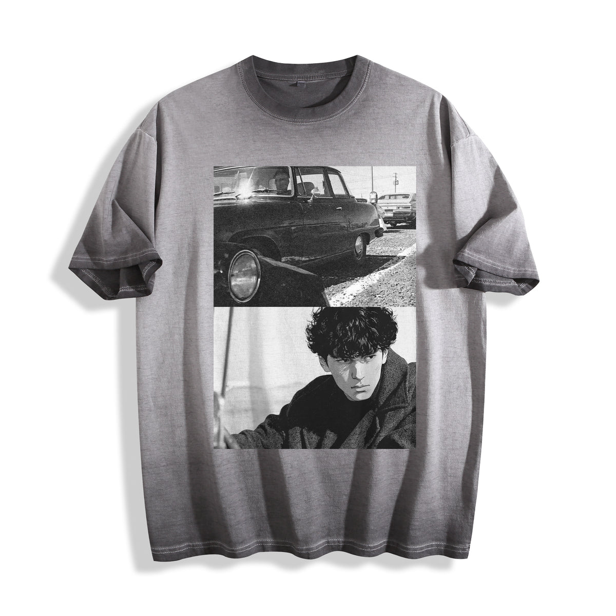 A gray mineral-wash t-shirt featuring a black and white graphic print of a vintage car and a portrait of a young man, displayed flat against a white background.