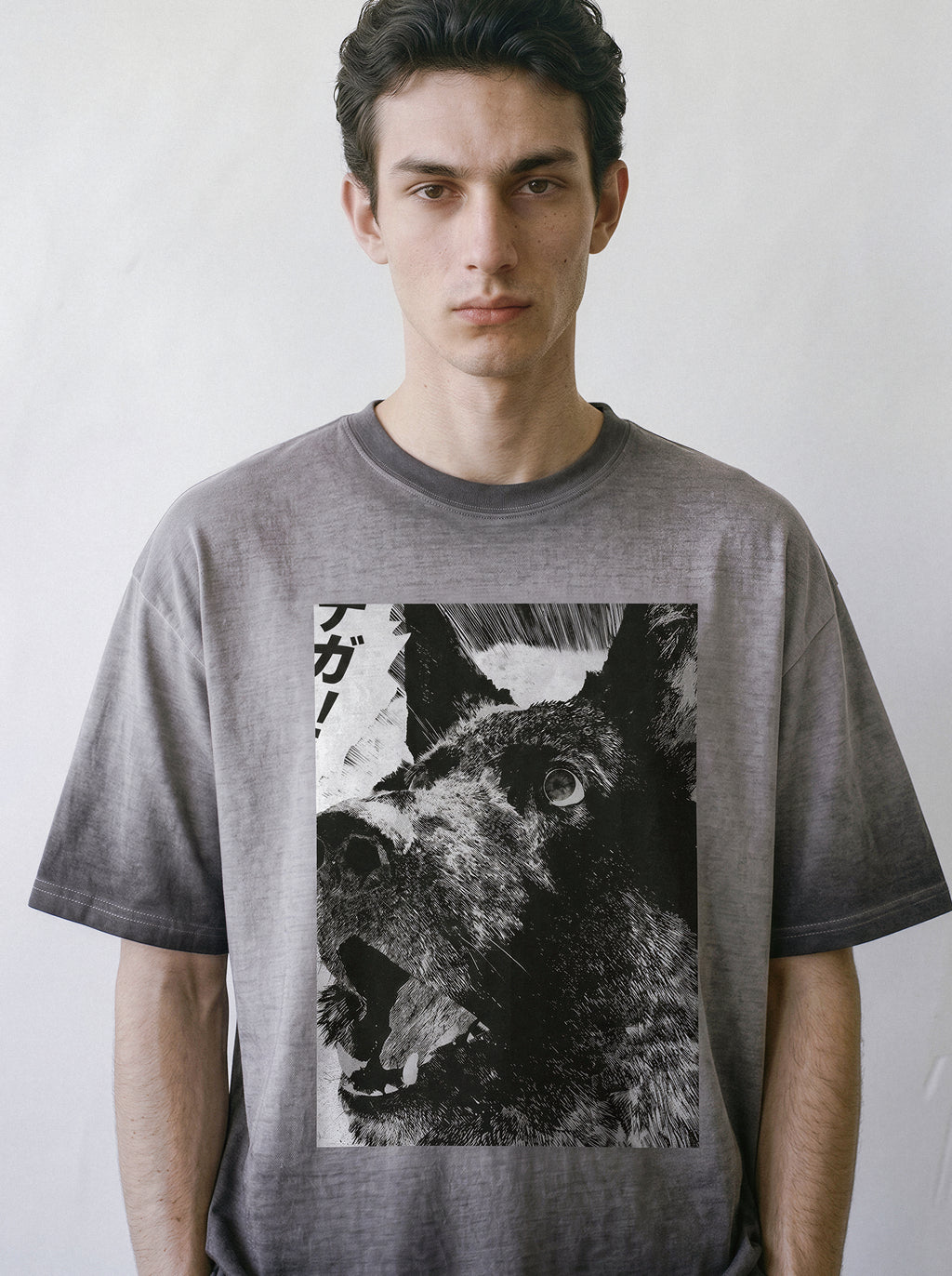 Flat lay product photography of an ombre grey heavyweight boxy fit t-shirt showcasing a monochrome comic panel print of a surprised and cute dog.