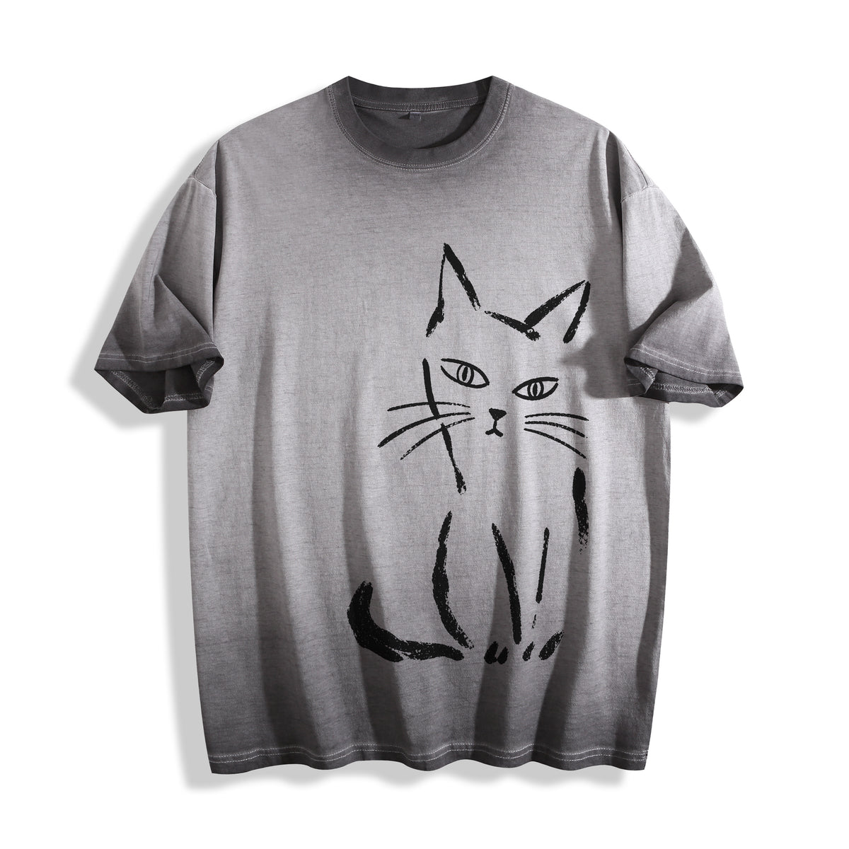 Clean flat lay product shot of an ombre grey heavyweight boxy fit t-shirt featuring a raw minimalist paint stroke feline illustration.