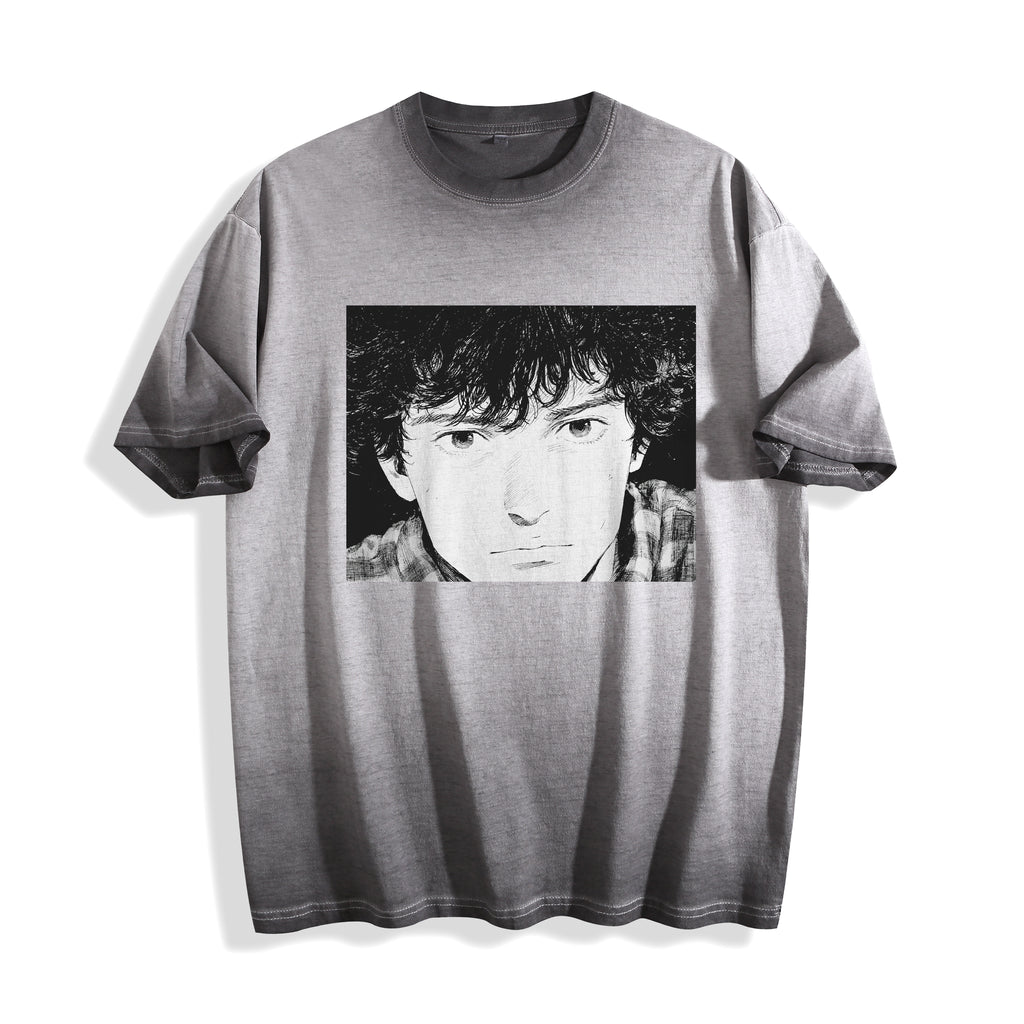 Flat lay product photography of an ombre grey heavyweight boxy fit t-shirt showcasing a 90s retro monochrome manga youth portrait on the front, displayed against a plain white background.