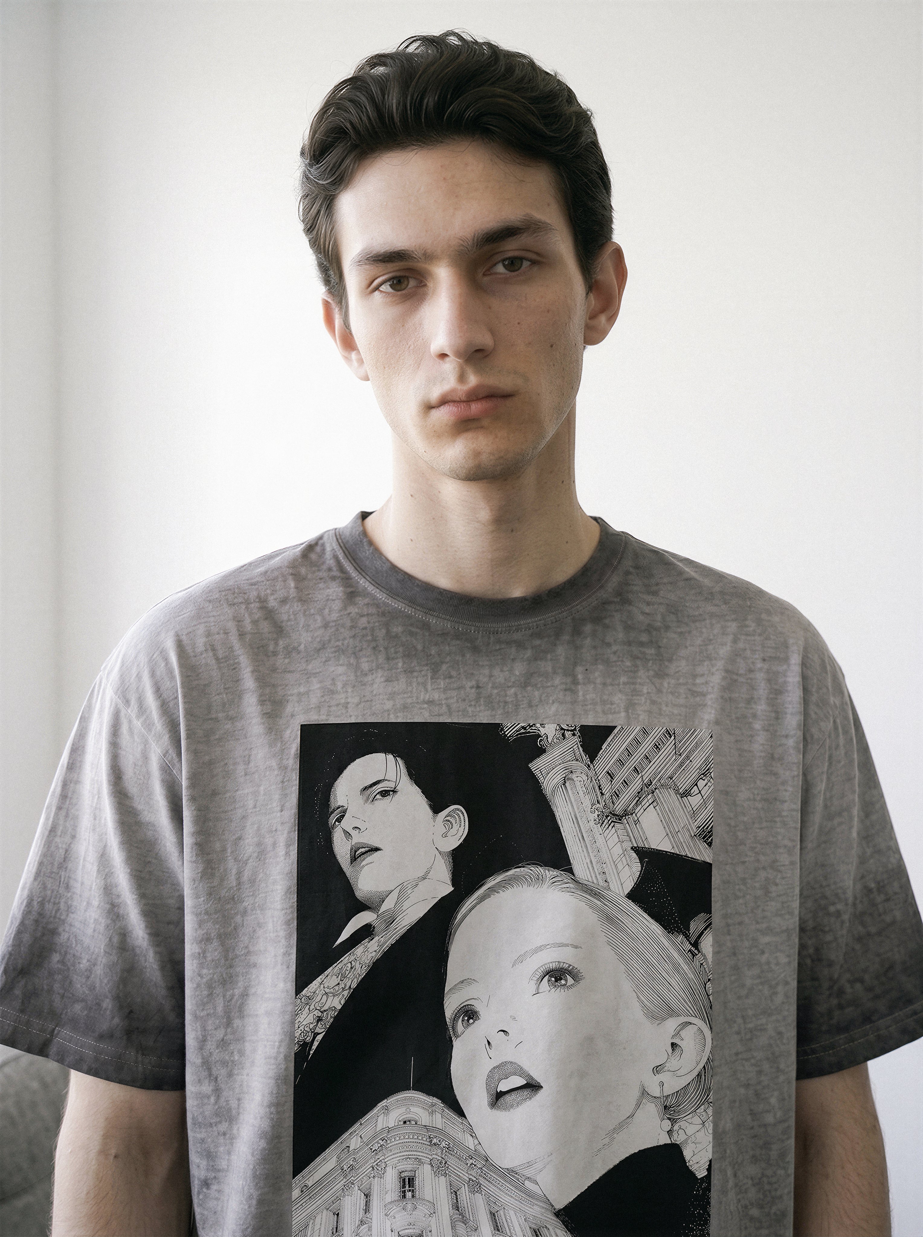 Front view portrait of a model wearing an ombre grey structured streetwear t-shirt with a 90s anime aesthetic monochrome comic graphic.