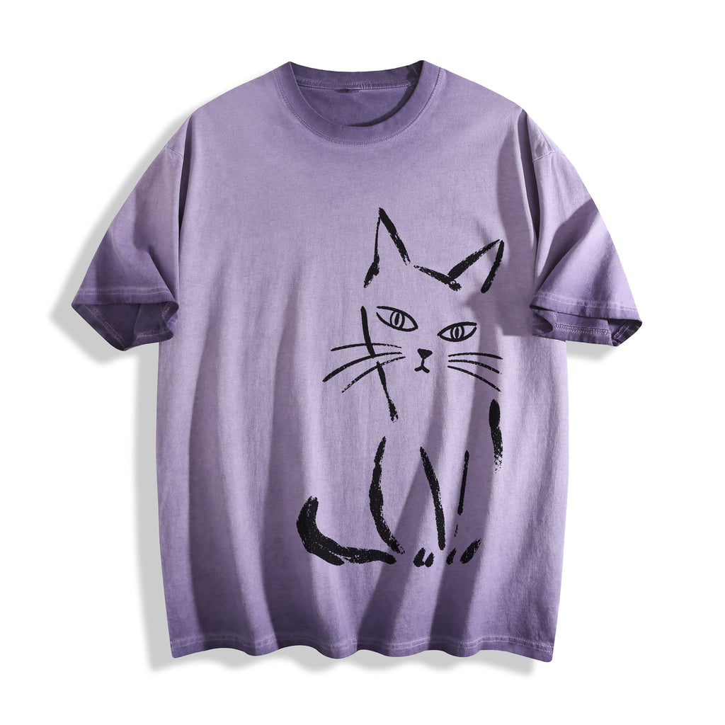 Flat lay product photography of an ombre violet heavyweight boxy fit t-shirt showcasing a minimalist black paint stroke judgmental cat graphic.