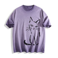 Flat lay product photography of an ombre violet heavyweight boxy fit t-shirt showcasing a minimalist black paint stroke judgmental cat graphic.