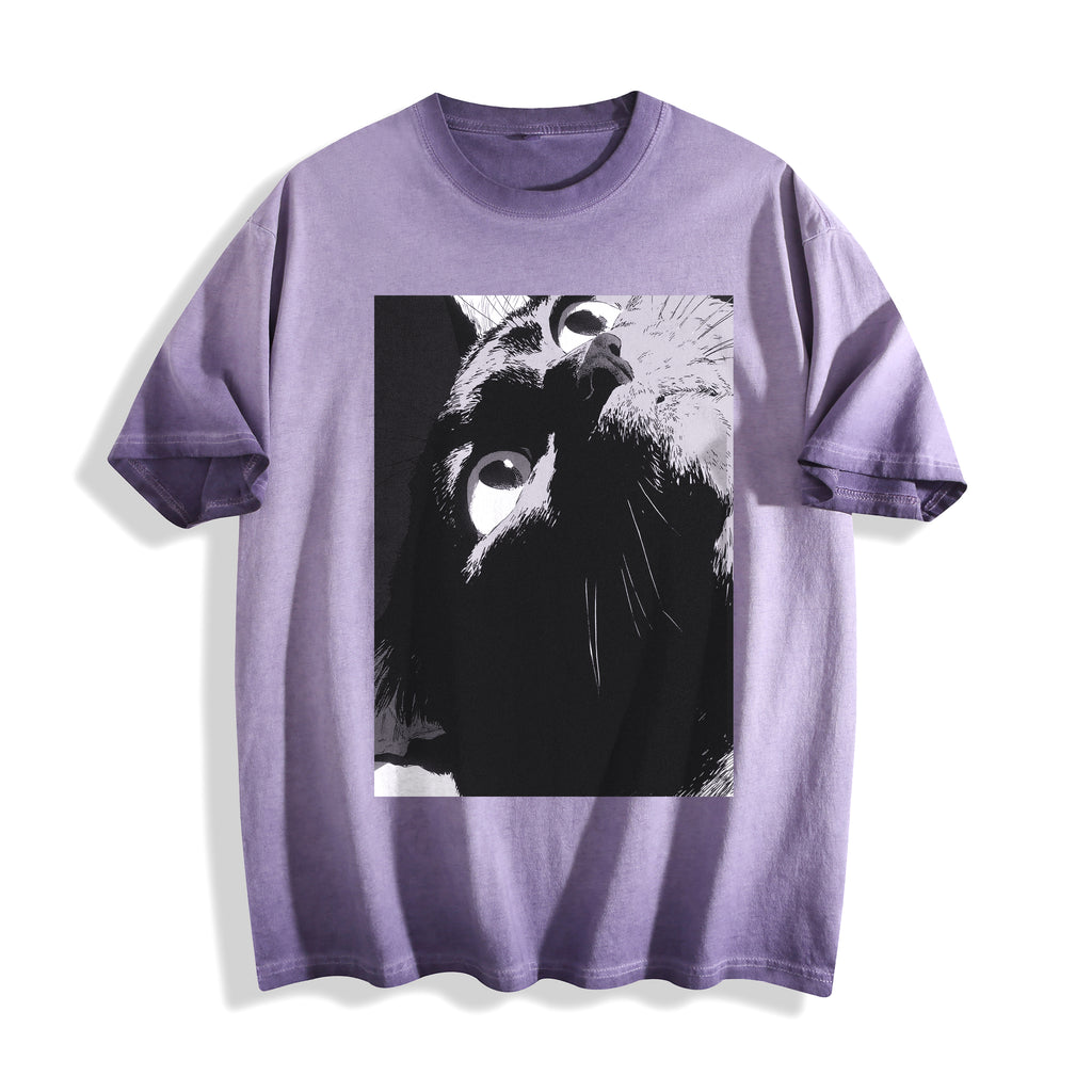 Flat lay product photography of an ombre violet heavyweight boxy fit t-shirt showcasing a black-and-white manga freeze-frame close-up of staring eyes.