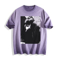 Flat lay product photography of an ombre violet heavyweight boxy fit t-shirt showcasing a black-and-white manga freeze-frame close-up of staring eyes.