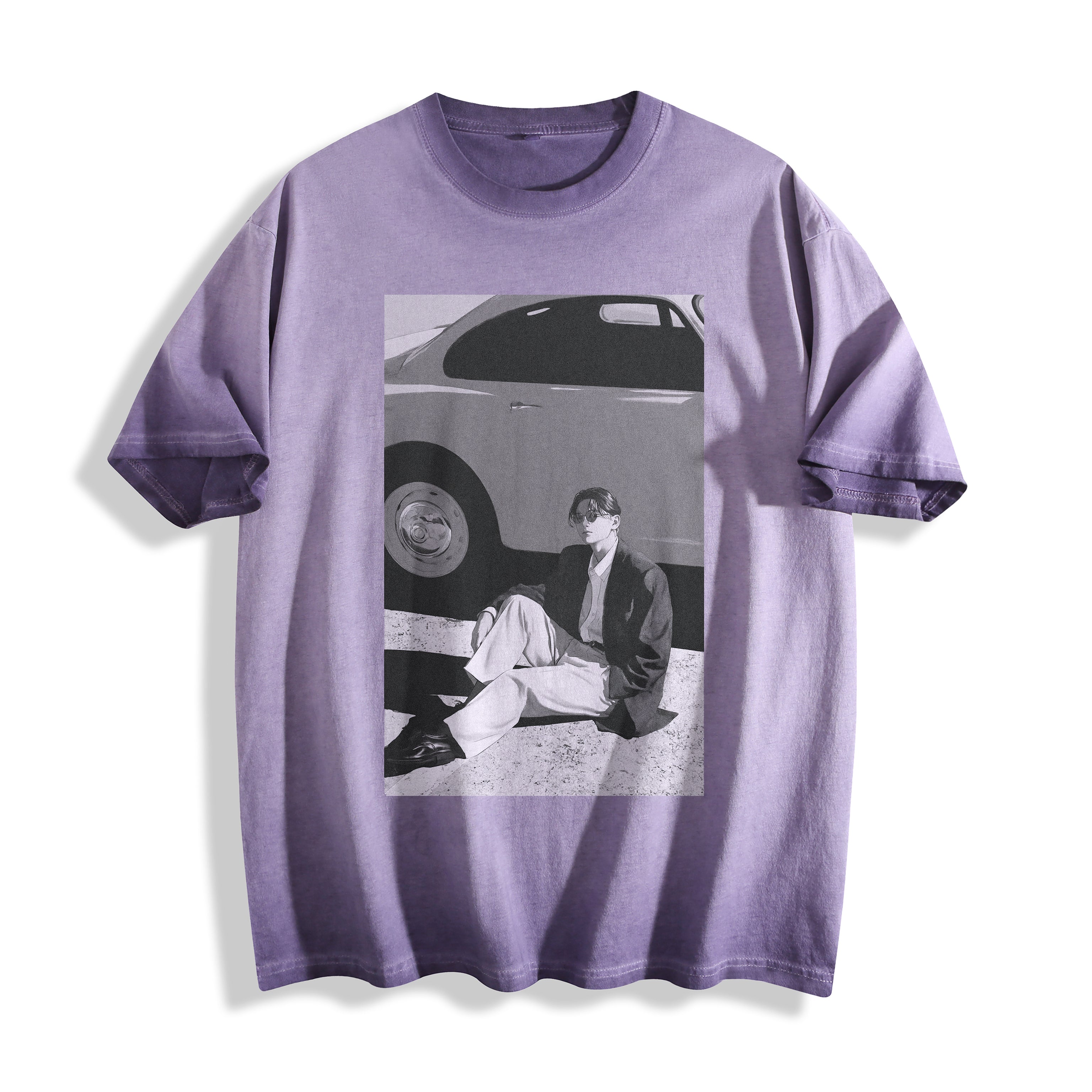 A lavender purple short-sleeve t-shirt with a striking 90s retro black and white photography print of a person sitting next to a vintage car, displayed on a clean white background.