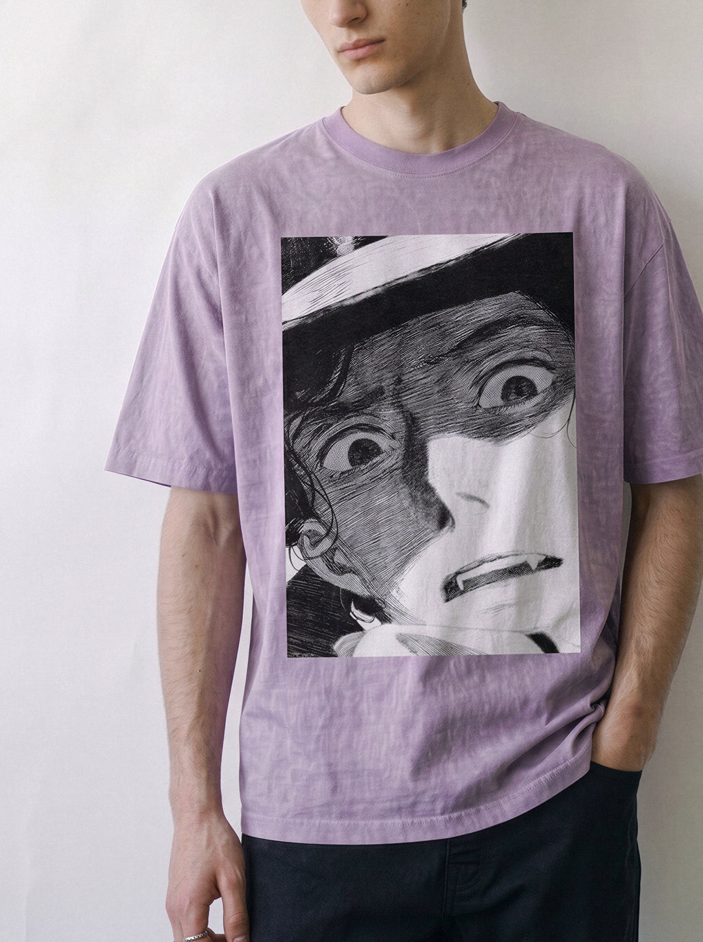 Front view of a male model with a direct stare, highlighting the heavy boxy fit of an ombre violet streetwear t-shirt with a striking monochrome manga face graphic.
