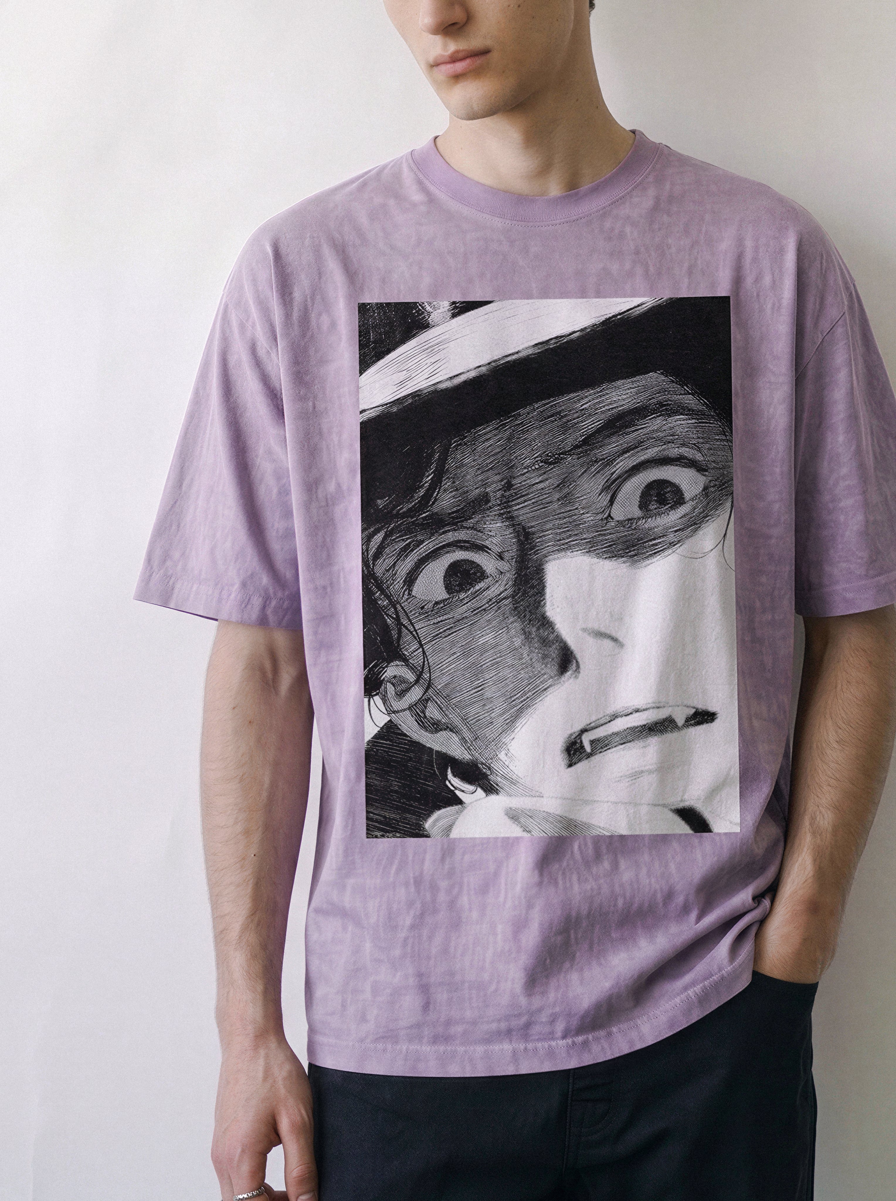 Front view of a male model with a direct stare, highlighting the heavy boxy fit of an ombre violet streetwear t-shirt with a striking monochrome manga face graphic.