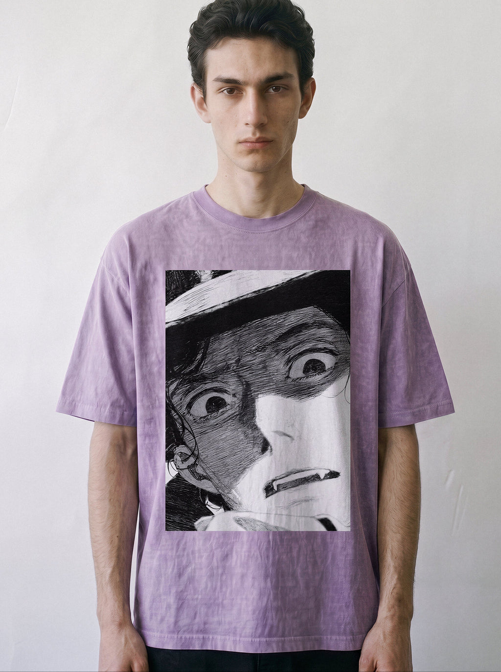 Front portrait of a male model looking directly at the camera, wearing an ombre violet heavyweight boxy fit graphic tee featuring a vintage black-and-white shocked manga panel illustration.