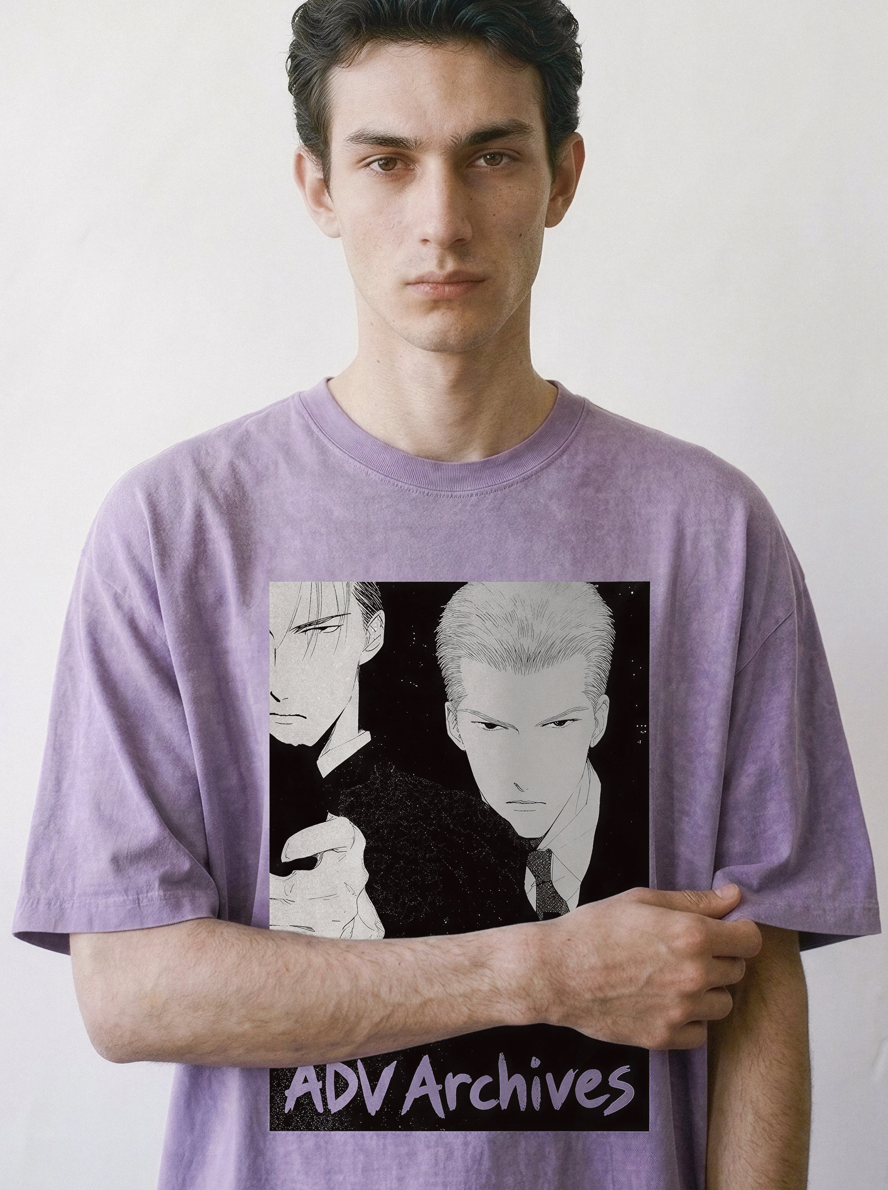A man wearing a lavender-purple t-shirt with a black and white graphic print, featuring a retro manga Yakuza execution print with two hitmen and the text 'ADV Archives' at the bottom, set against a plain off-white background.