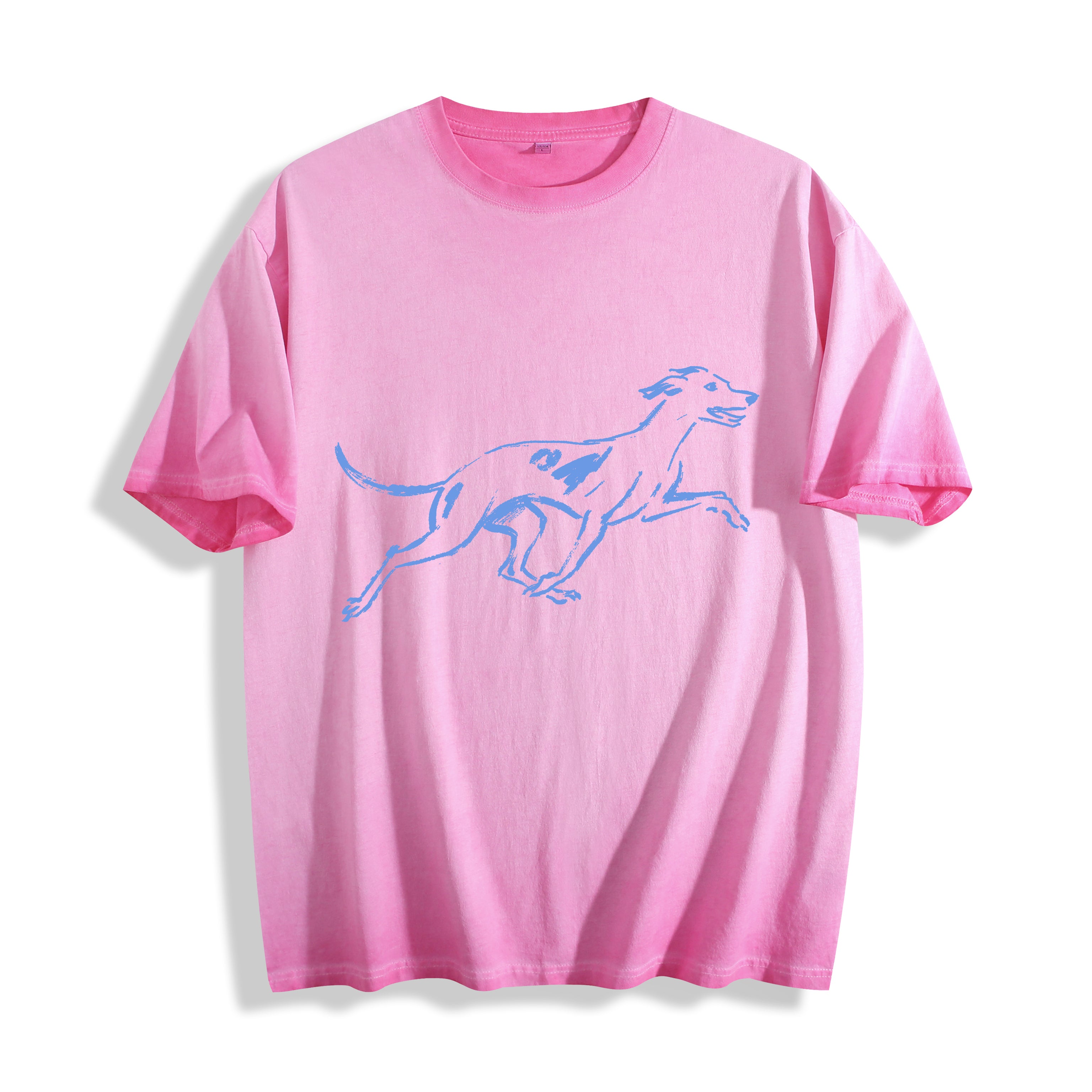Top-down flat lay view of a pink graphic tee displaying a striking running dog line art illustration.