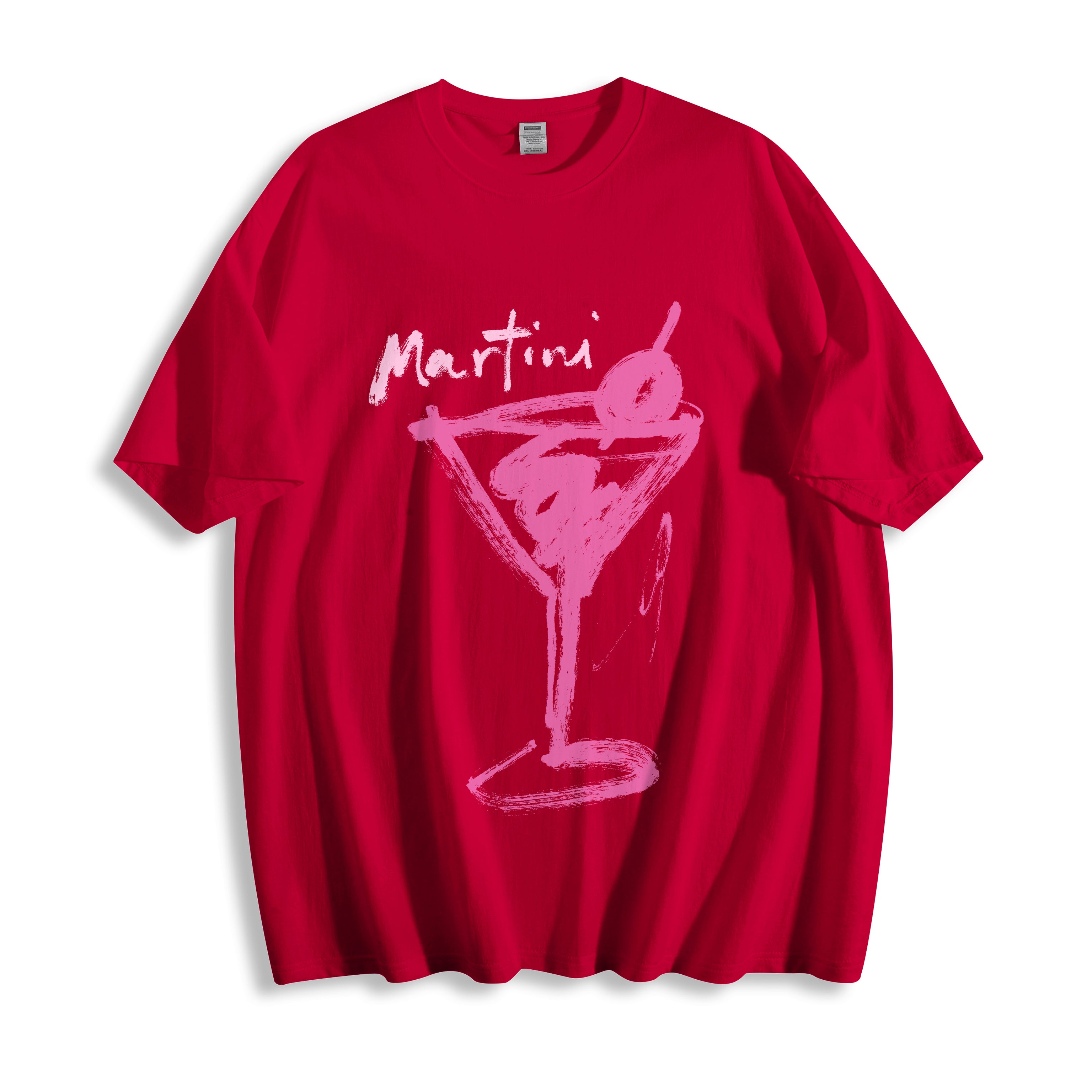 Top-down flat lay view of a red graphic tee displaying a striking expressive ink martini glass line art design and the word 'Martini' across the chest, shown on a plain white background.