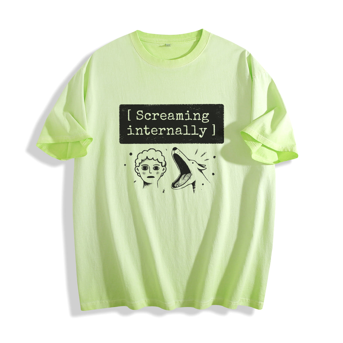 A flat lay of an acid lime screaming internally ironic graphic tee, blending a vibrant neon color with a dry humor mental breakdown aesthetic.