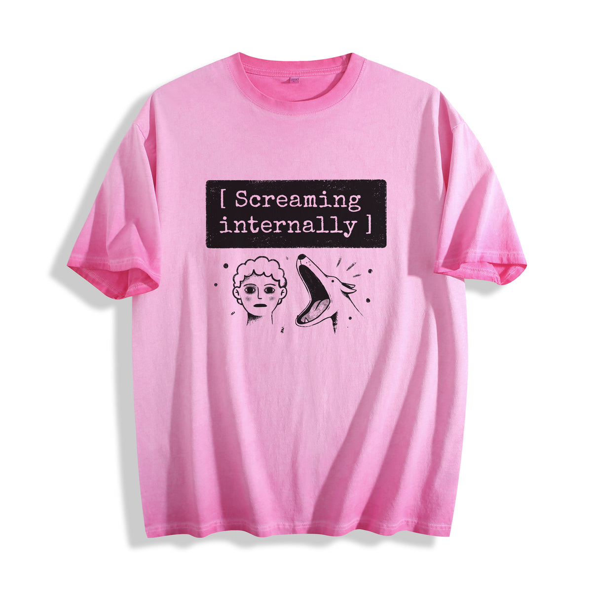 A flat lay of an aura pink screaming internally ironic graphic tee, contrasting a soft pastel tone with an existential and ironic graphic design.