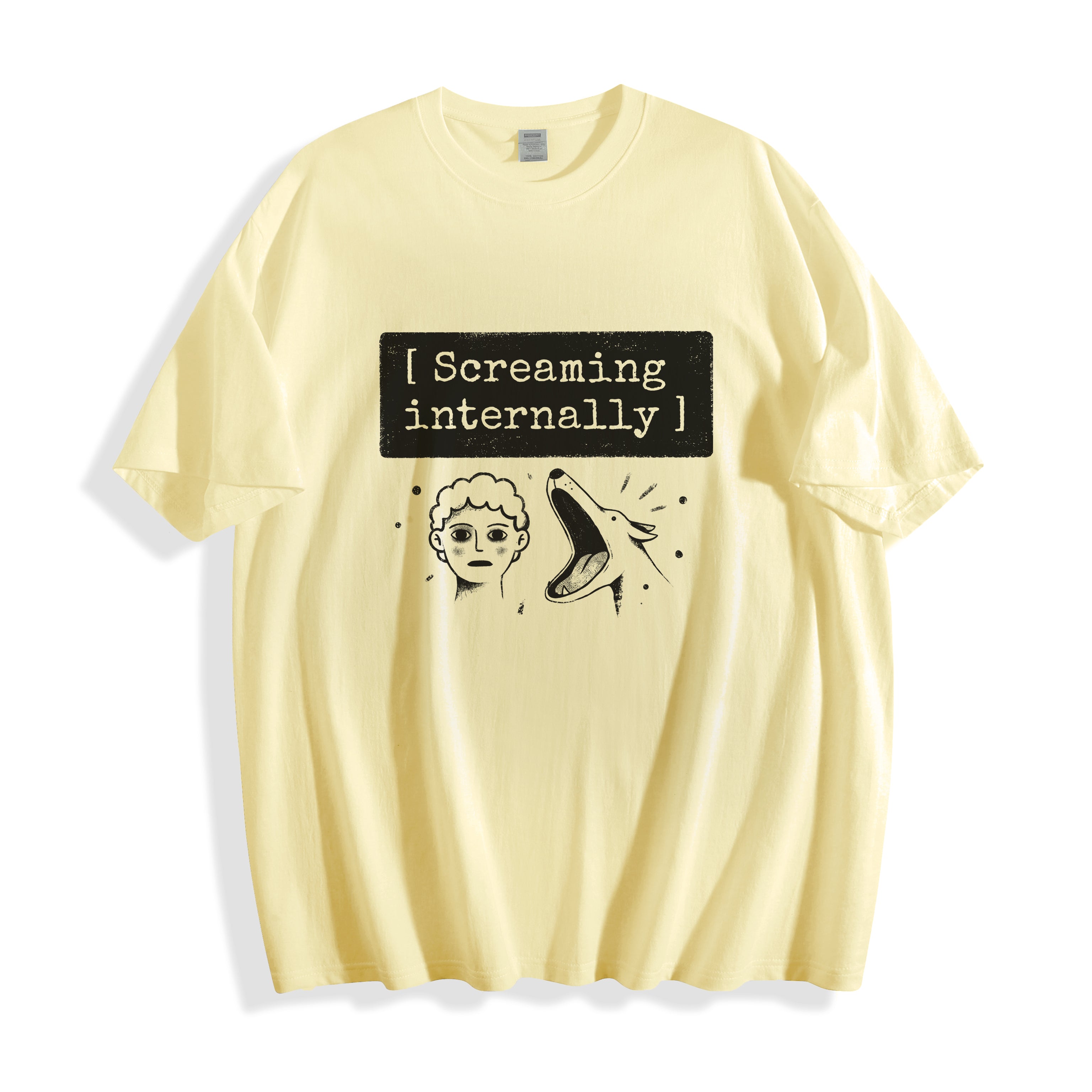 A flat lay of a butter yellow screaming internally psychological graphic tee, contrasting a warm neutral base with the striking psychological graphic print.