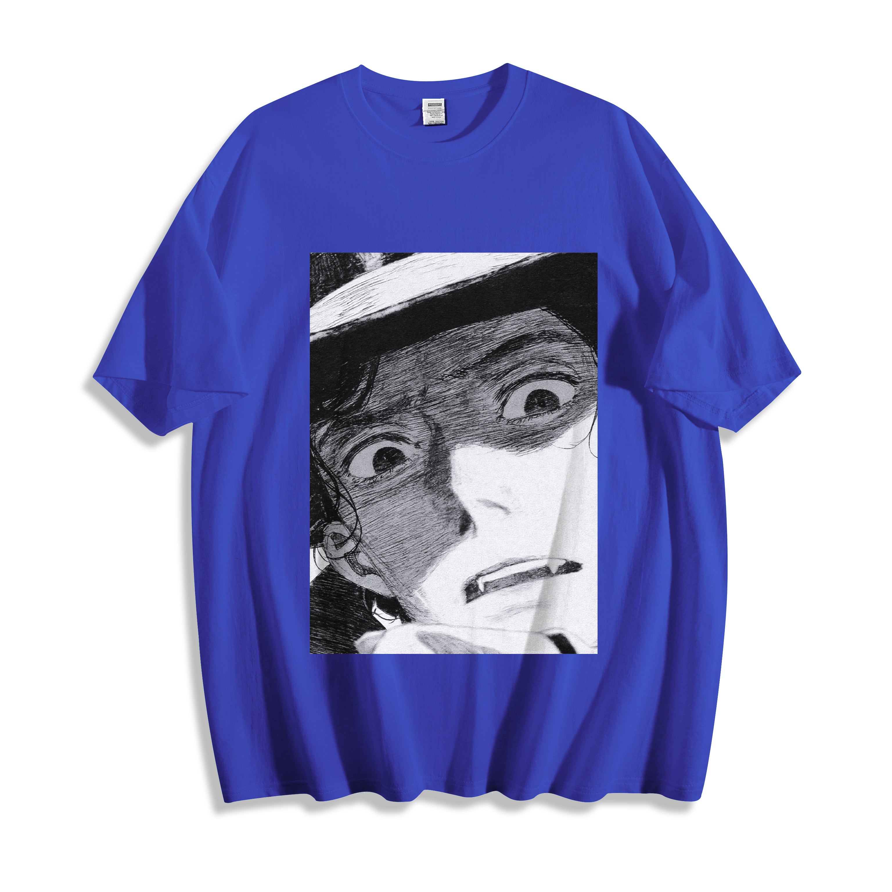 A flat lay of a blue shocked face manga panel graphic tee, contrasting a vibrant base color with the striking vintage anime panel print.