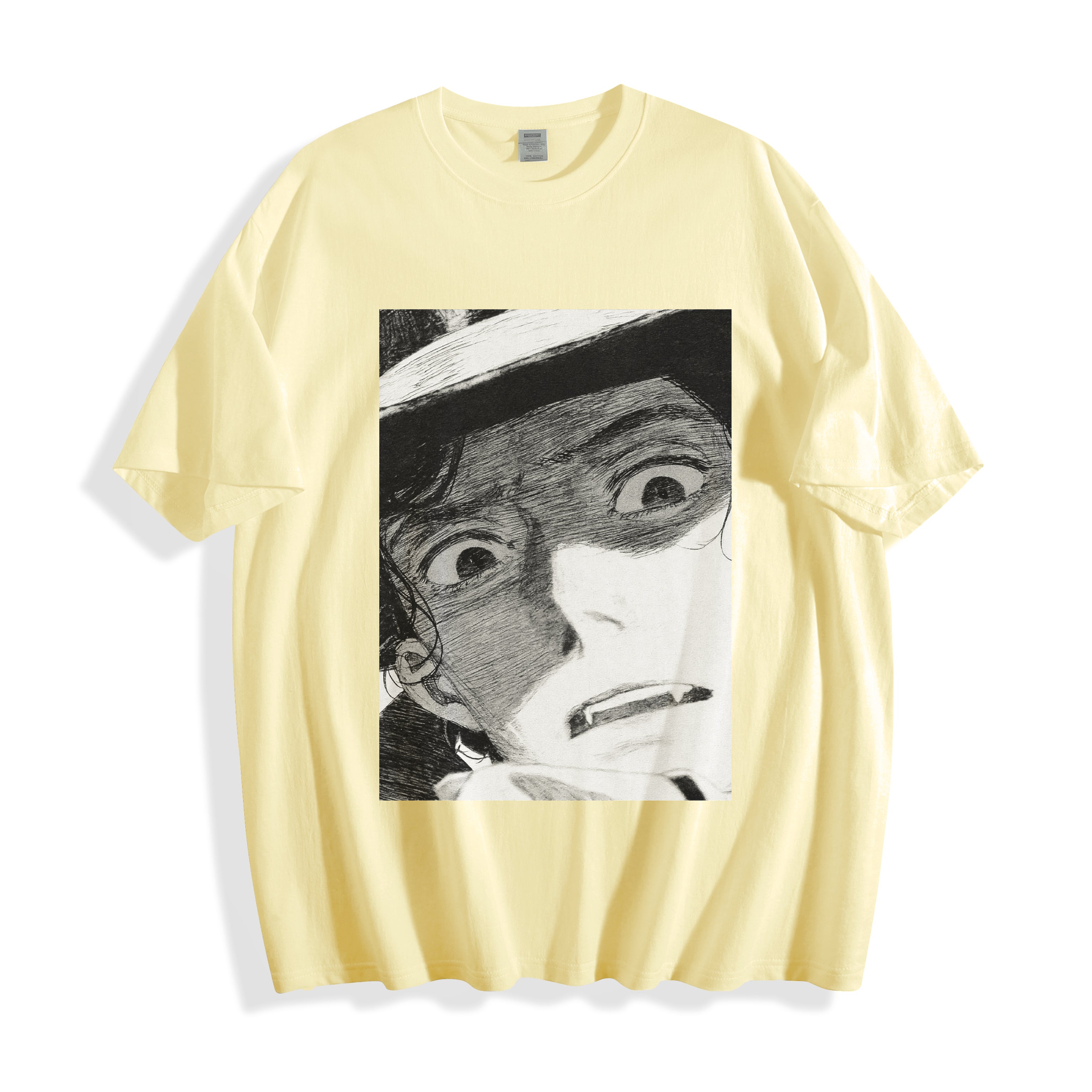 A flat lay of a butter yellow shocked face manga panel graphic tee, blending a warm tone with a bold, raw emotion independent manga design.