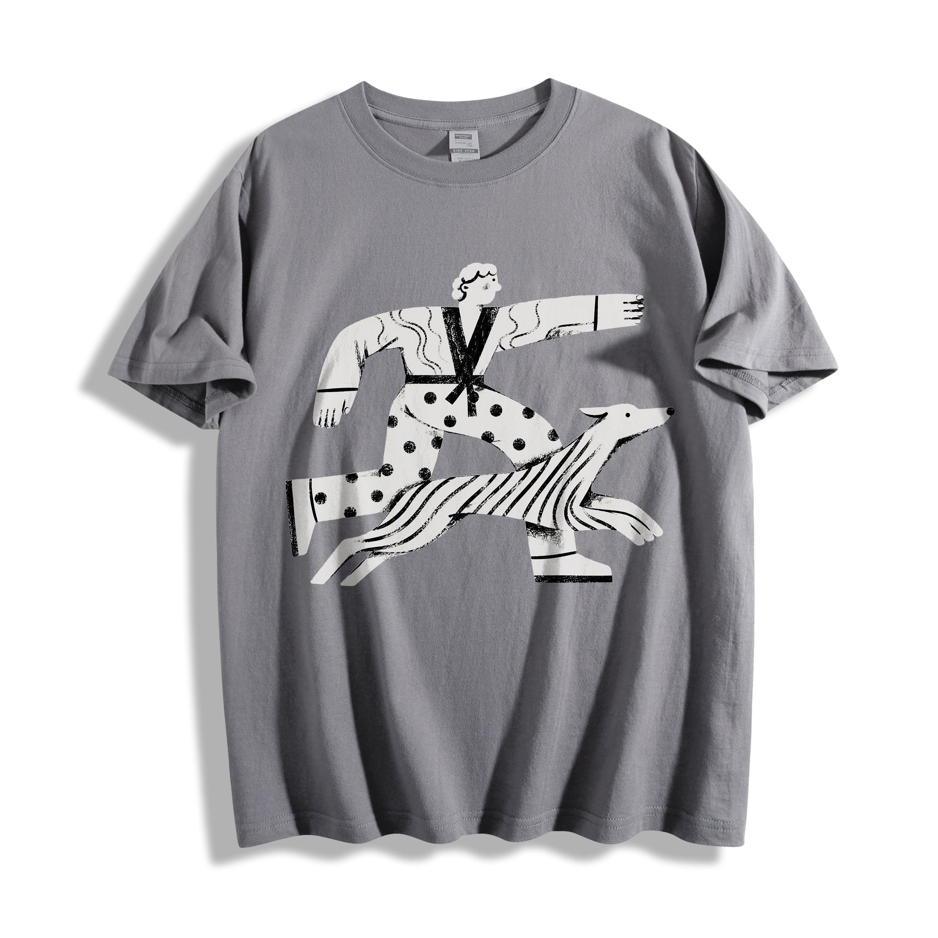 A flat lay of a gray striding away line art graphic tee, featuring a pure line art print of a person and dog striding with absolute conviction.