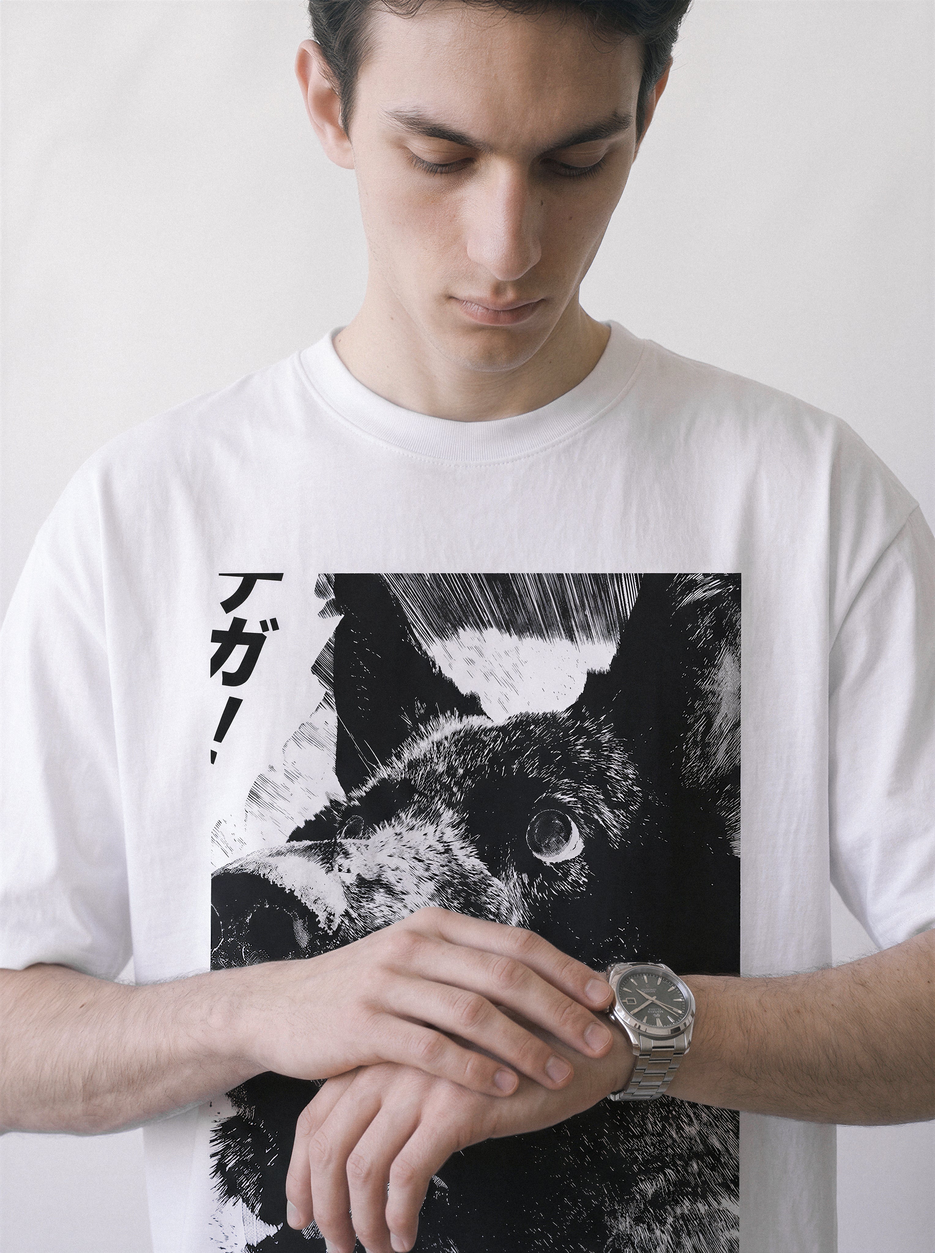 A male model looking down at his watch wearing a white surprised dog comic panel graphic tee, highlighting the katakana sound effect and ink manga style.