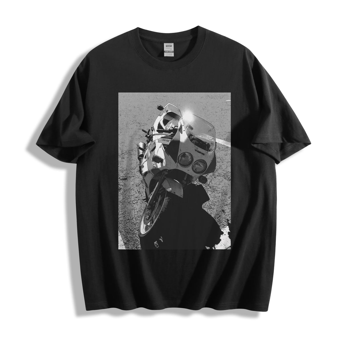 A flat lay of a black 90s monochrome motorcycle photography tee, contrasting a dark background with the high-contrast analog speed tool graphic.